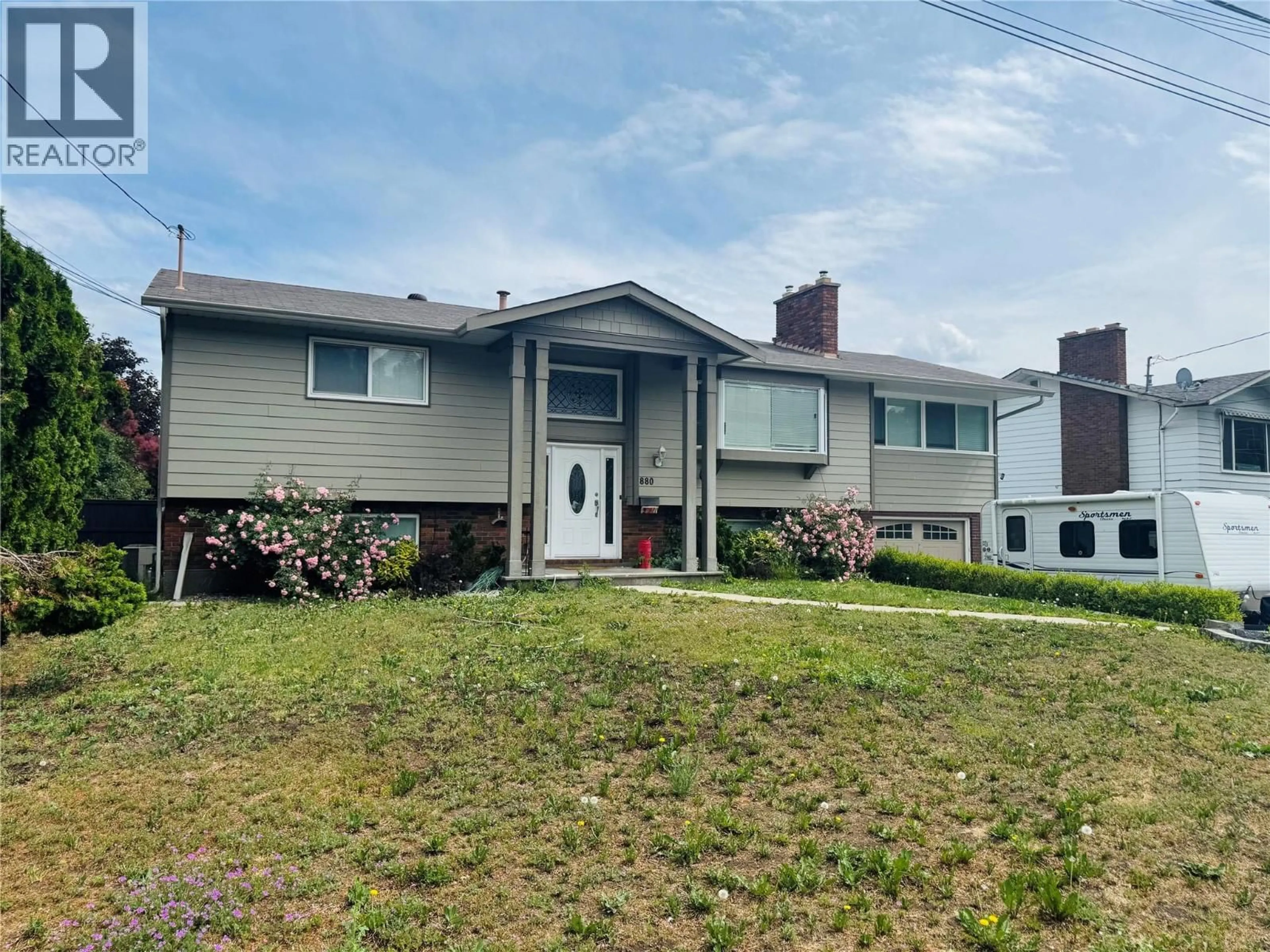 Home with vinyl exterior material, street for 880 TAMARACK DRIVE, Kelowna British Columbia V1X5M1