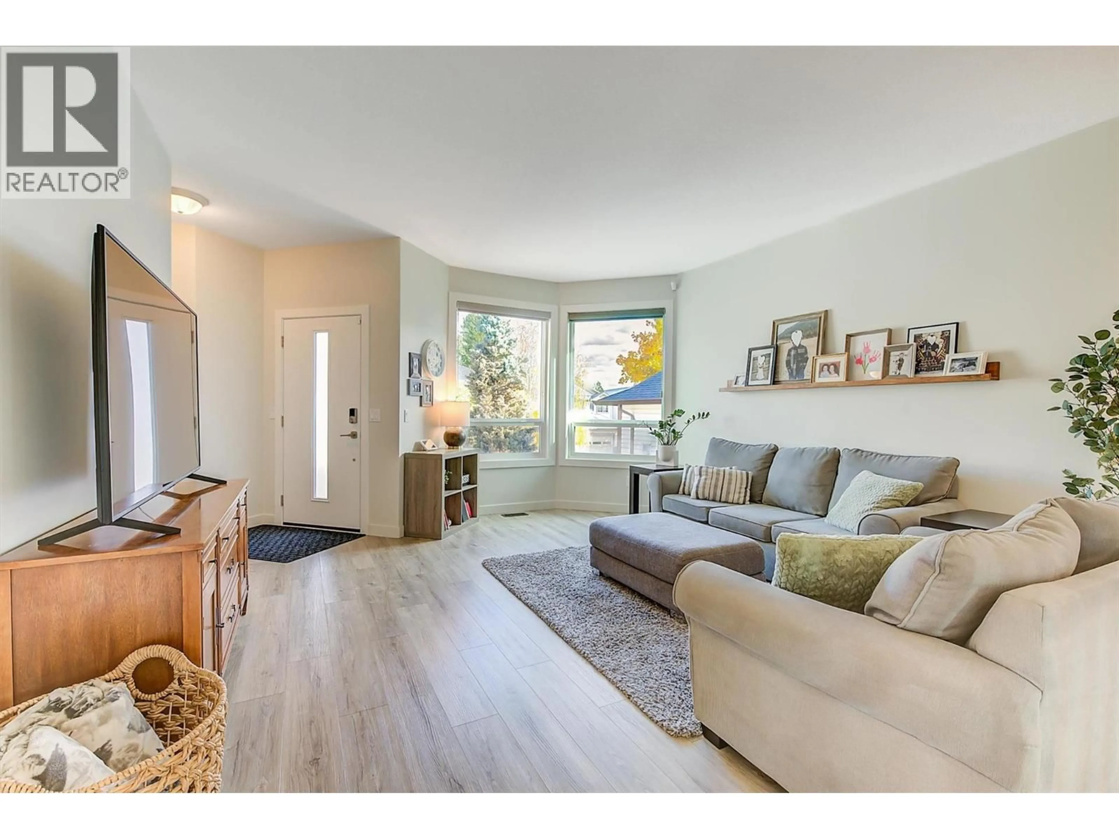 Living room with furniture, wood/laminate floor for 2083 ROSEFIELD DRIVE, West Kelowna British Columbia V1Z3Y8