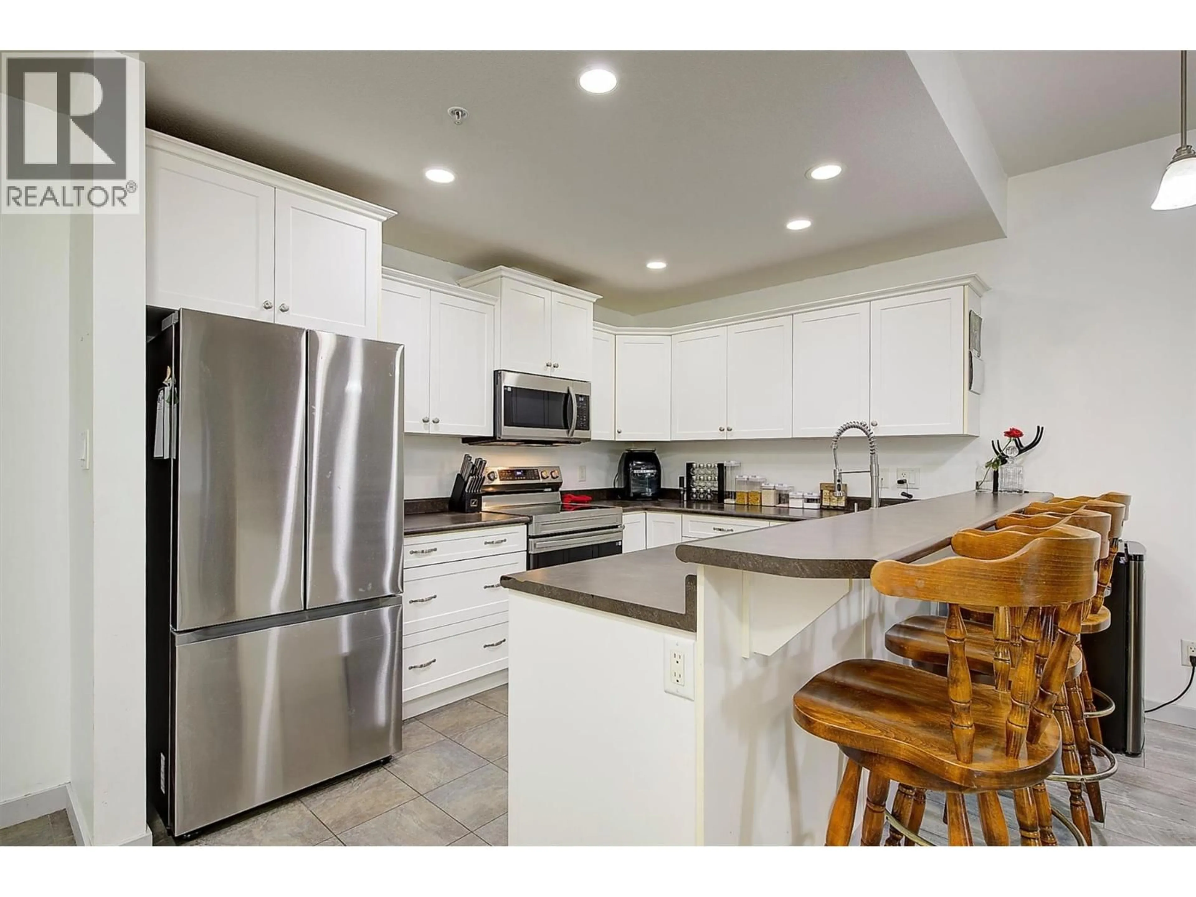Open concept kitchen, ceramic/tile floor for 305 - 345 MILLS ROAD, Kelowna British Columbia V1X4G9
