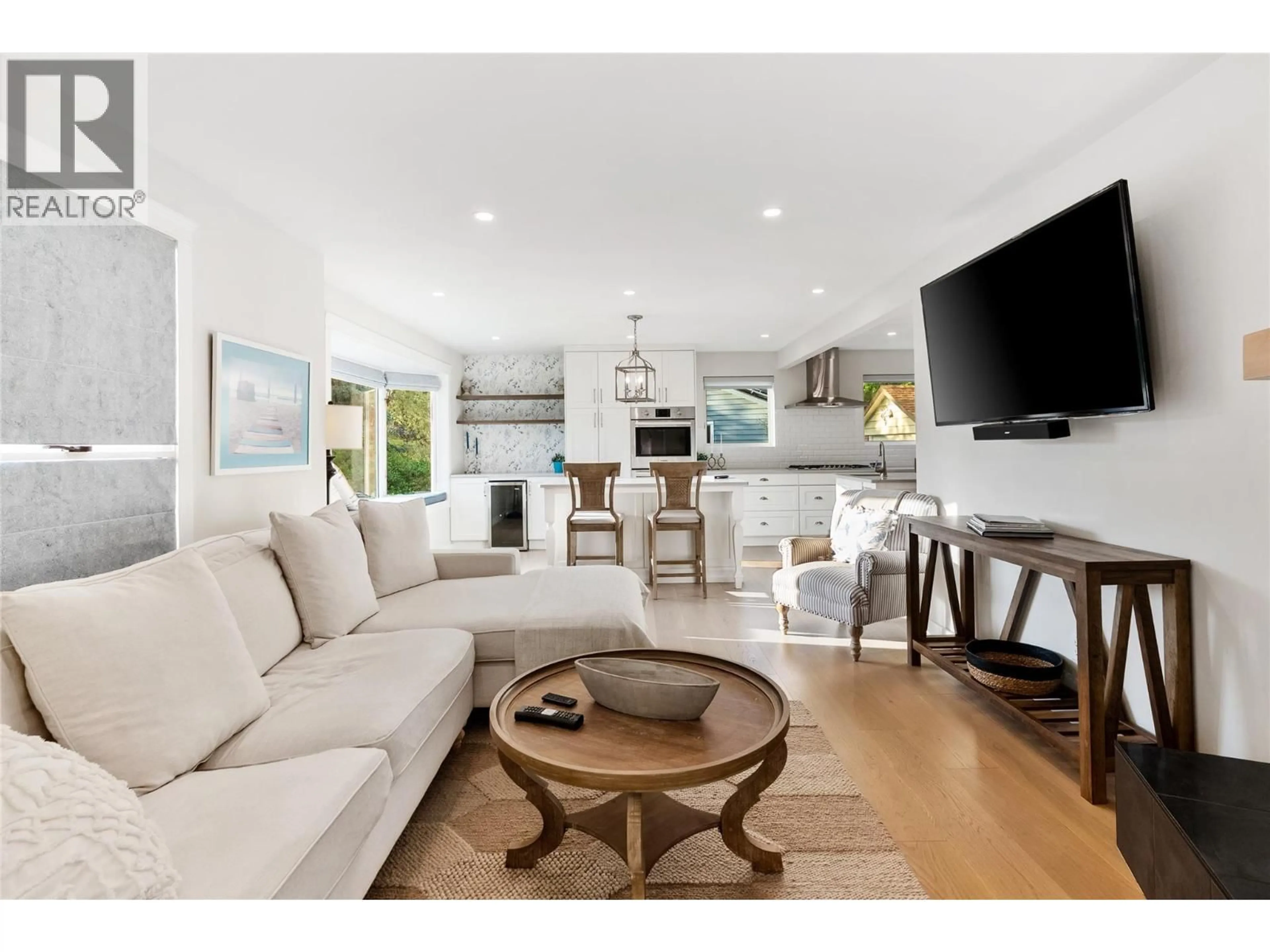 Living room with furniture, wood/laminate floor for 4471 NOTTINGHAM ROAD, Kelowna British Columbia V1W1V1