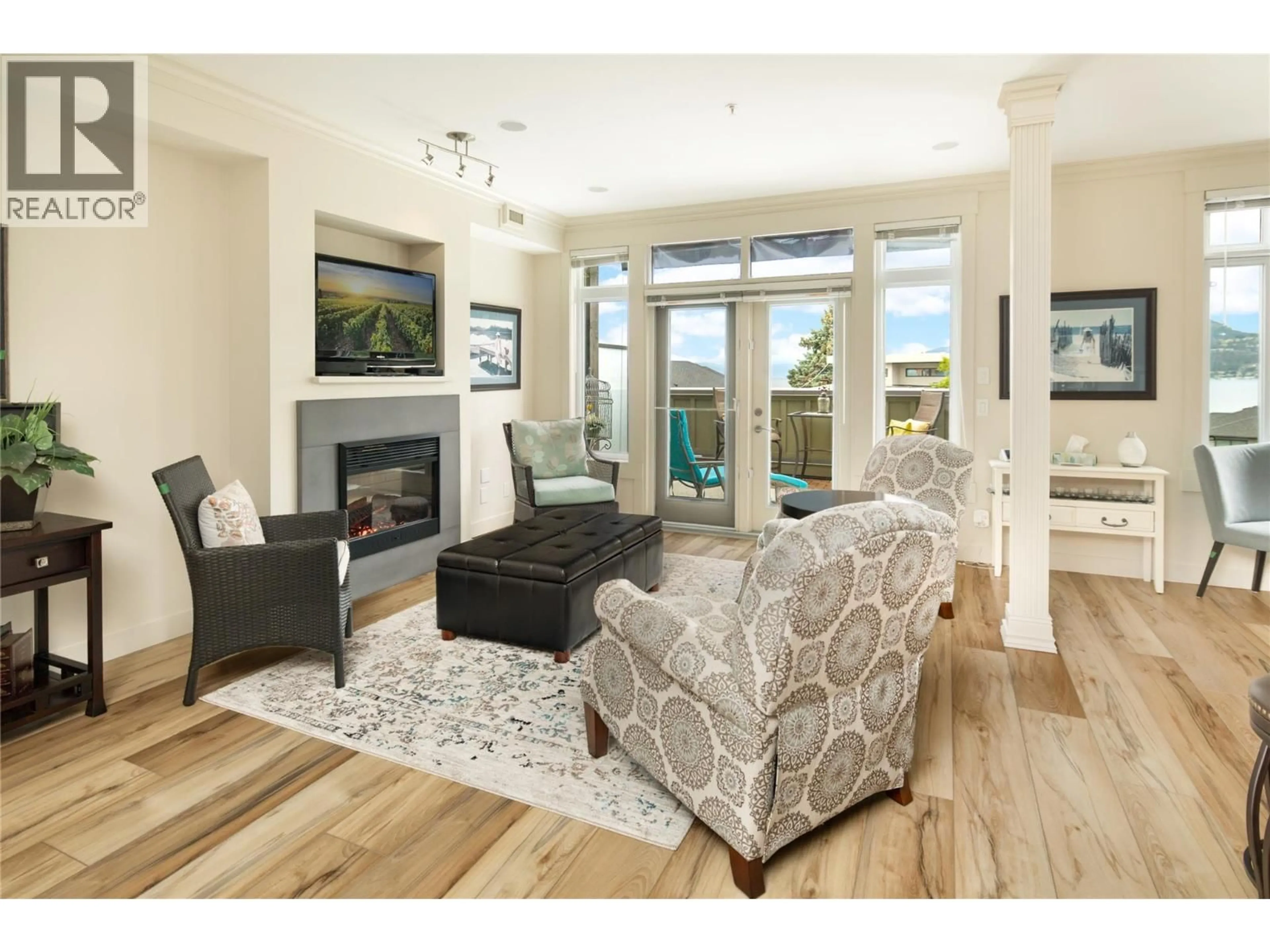 Living room with furniture, wood/laminate floor for 307 - 2901 ABBOTT STREET, Kelowna British Columbia V1Y1G7