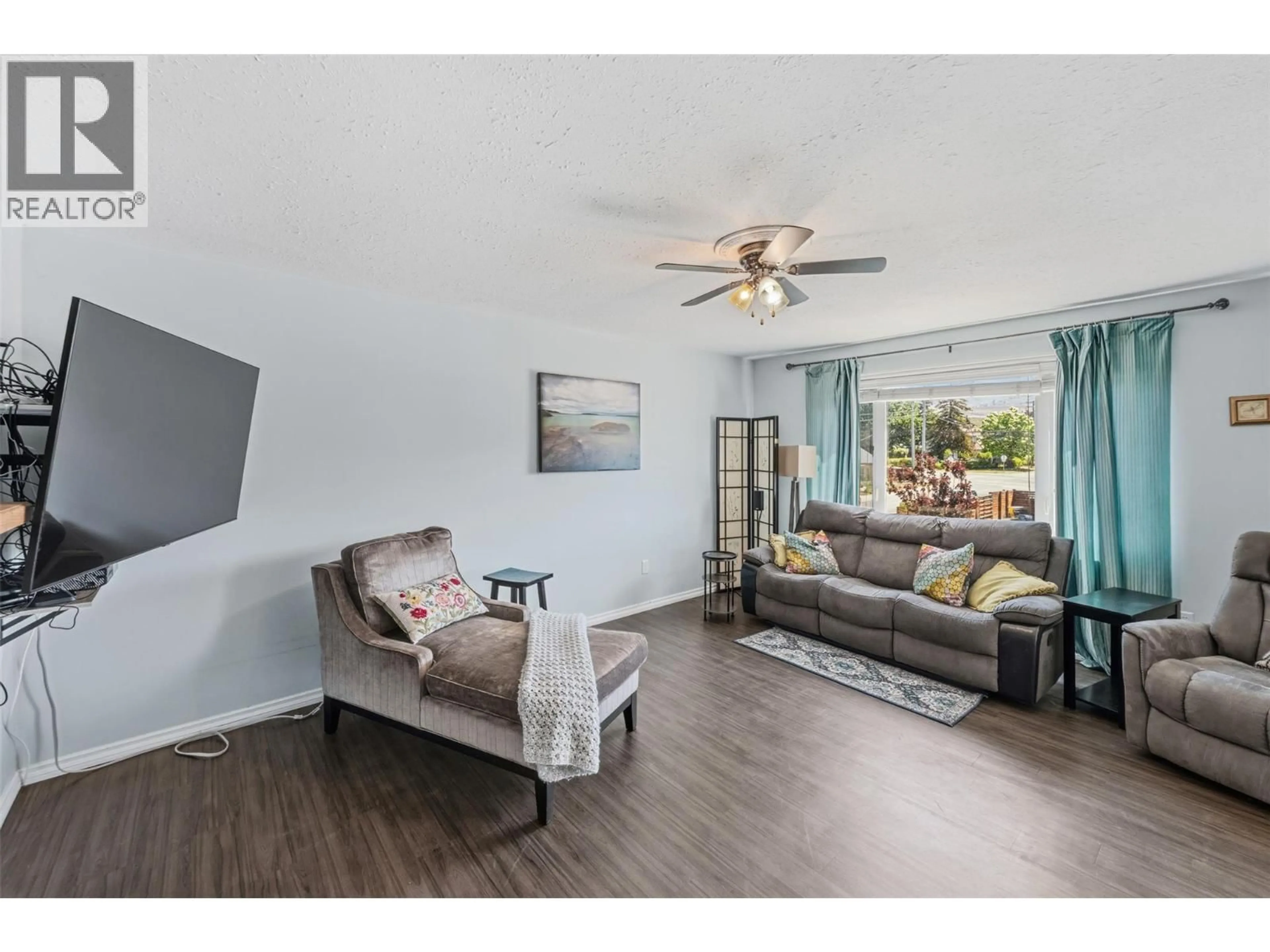 Living room with furniture, wood/laminate floor for 491 EASTSIDE AVENUE, Oliver British Columbia V0H1T4