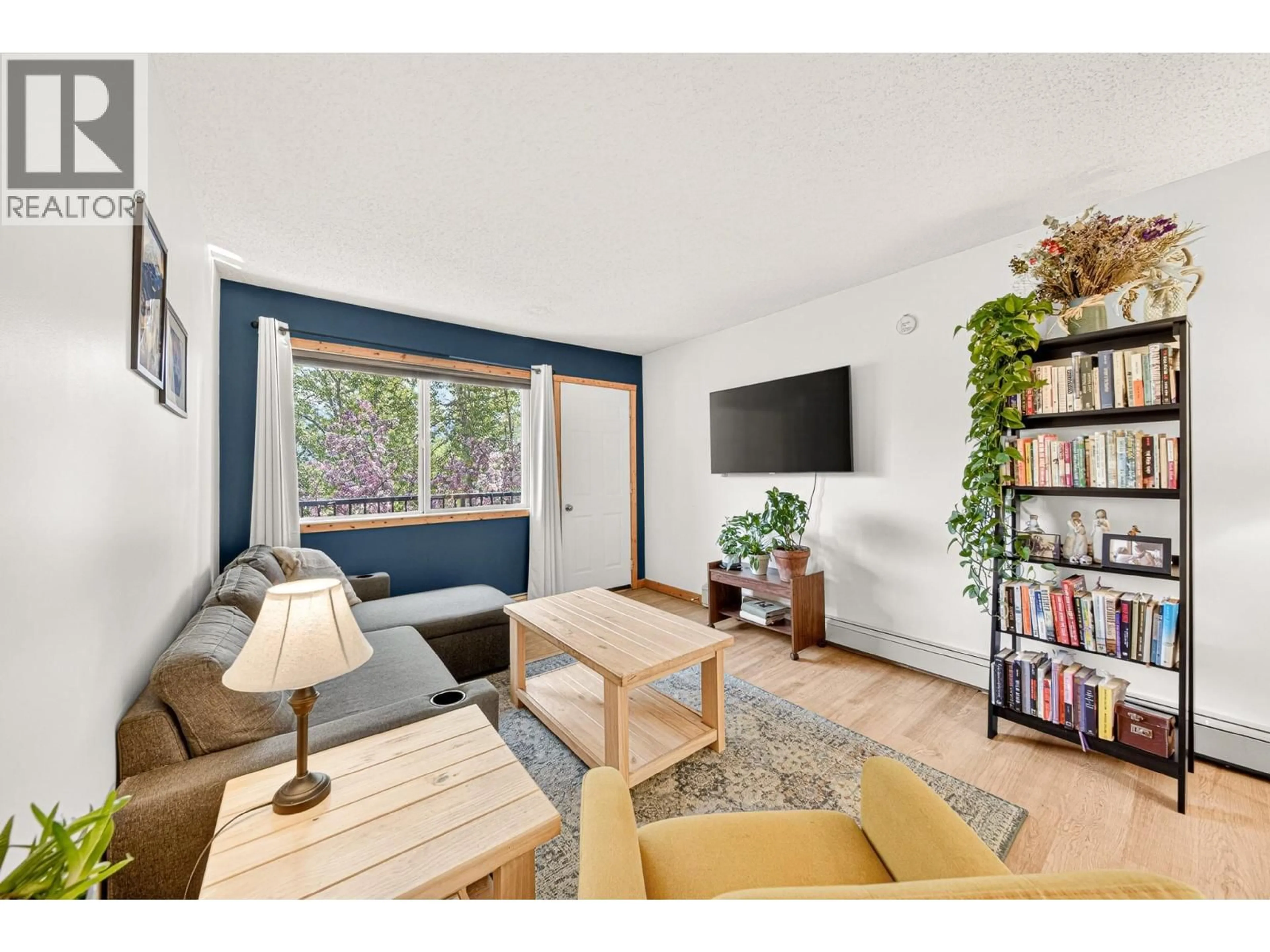 Living room with furniture, wood/laminate floor for 308 - 65 COKATO ROAD, Fernie British Columbia V0B1M4