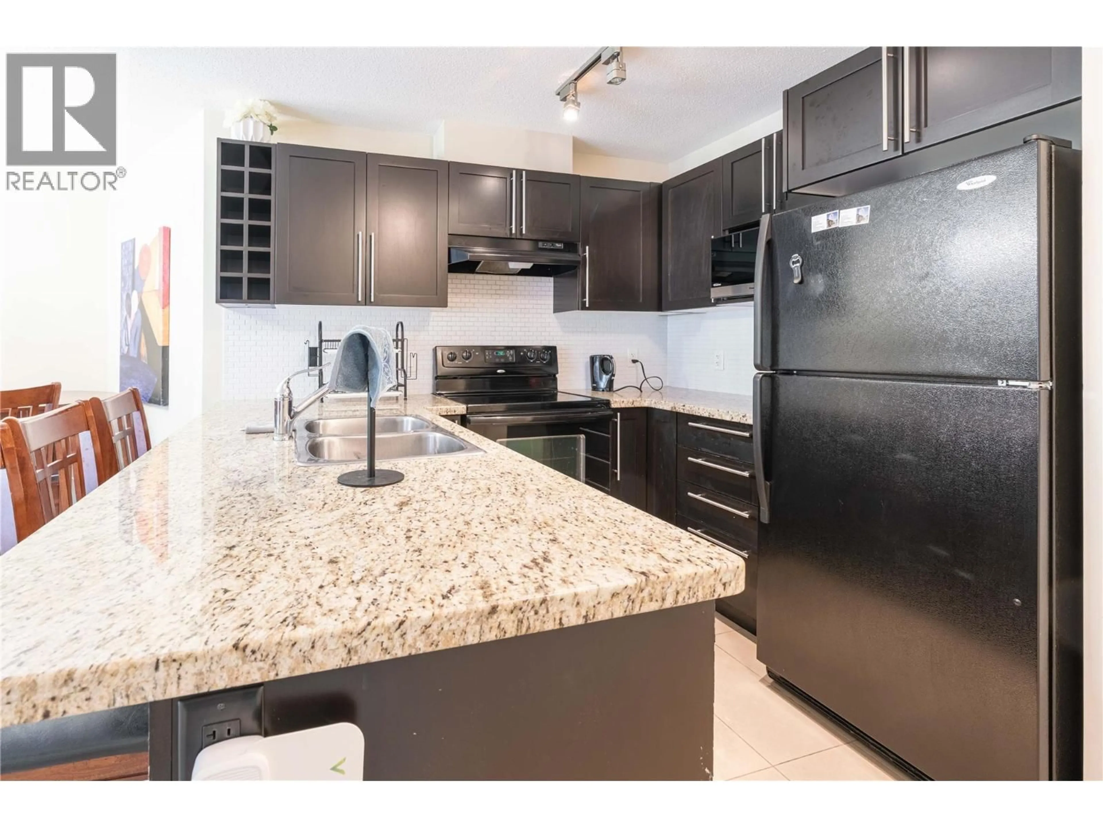 Open concept kitchen, ceramic/tile floor for 218 - 1089 SUNSET DRIVE, Kelowna British Columbia V1Y9Z3