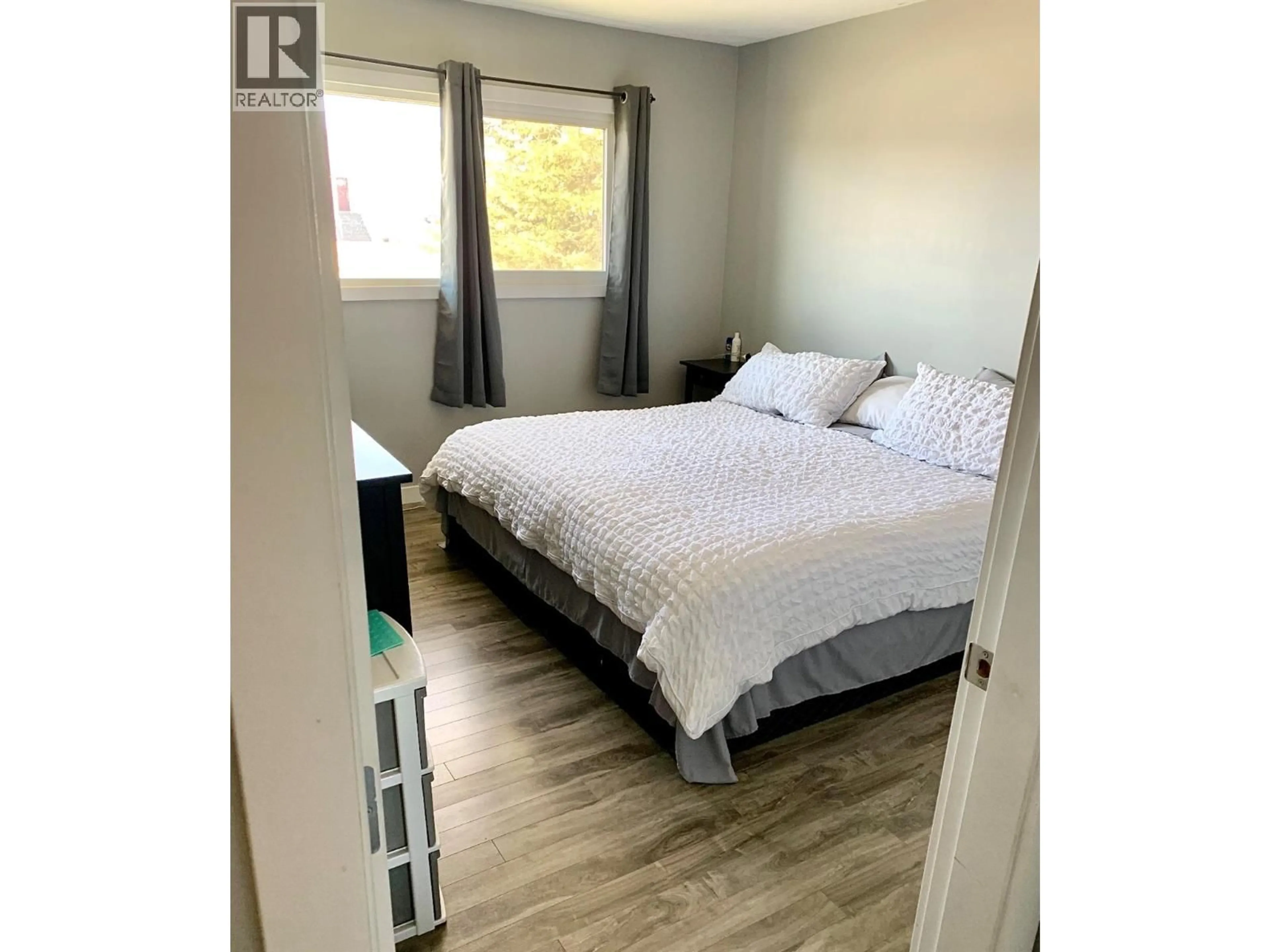 Bedroom with bed, wood/laminate floor for 1312 116 AVENUE, Dawson Creek British Columbia V1G3E7