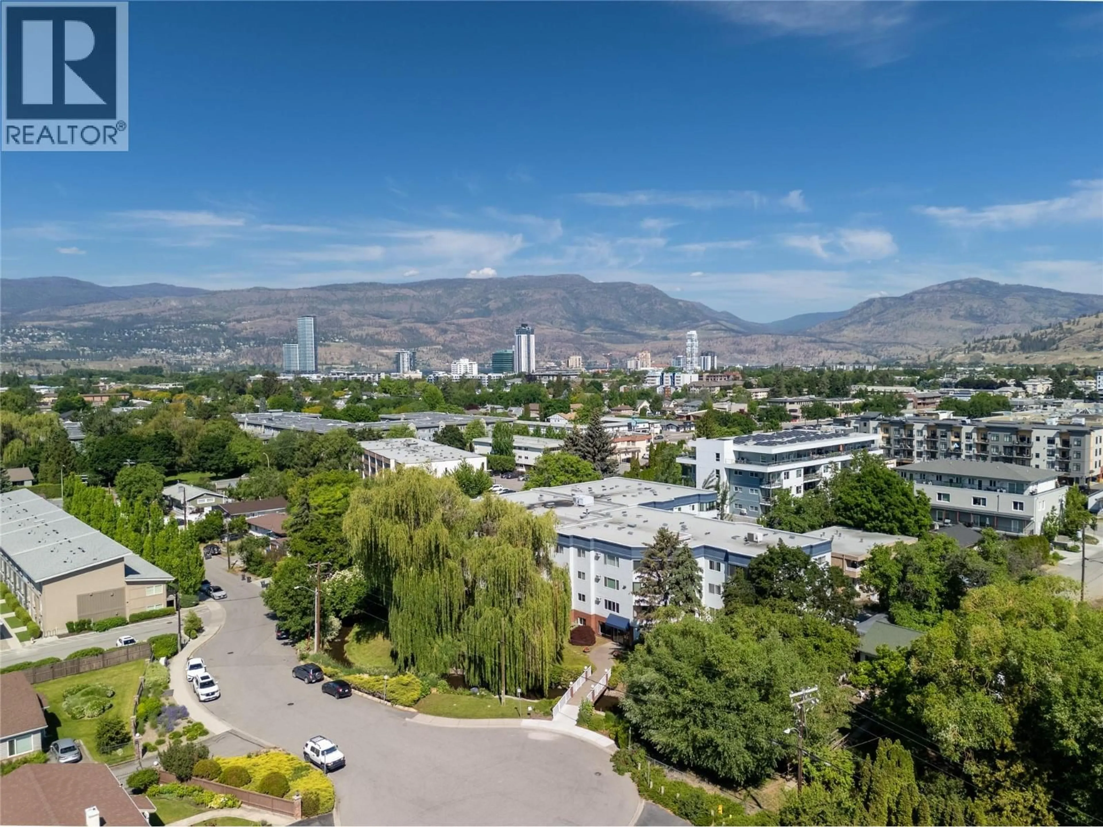 A pic from outside/outdoor area/front of a property/back of a property/a pic from drone, mountain view for 101 - 1170 BROOKSIDE AVENUE, Kelowna British Columbia V1Y5T4