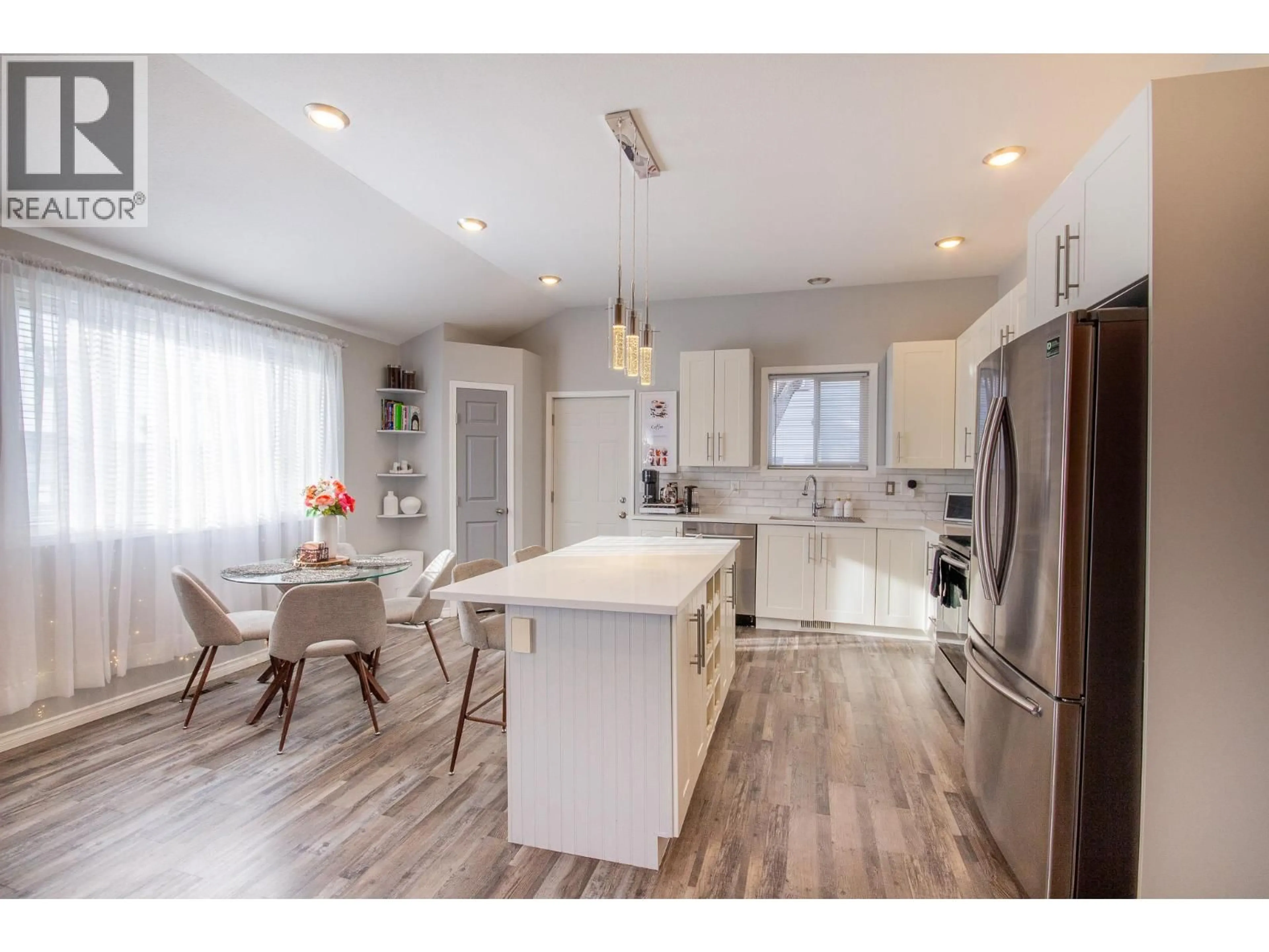 Open concept kitchen, wood/laminate floor for 1500 96 AVENUE, Dawson Creek British Columbia V1G1L6