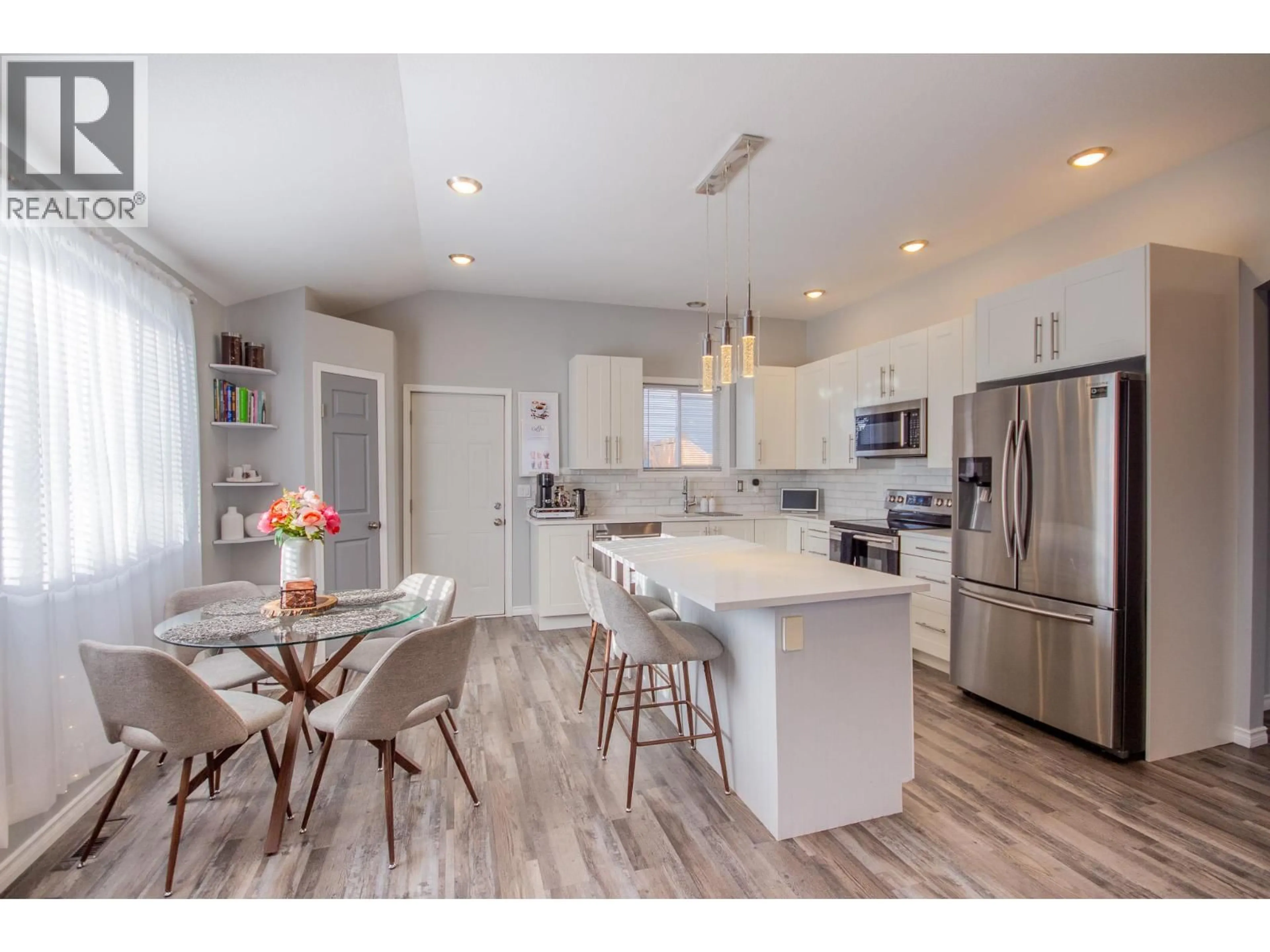 Open concept kitchen, wood/laminate floor for 1500 96 AVENUE, Dawson Creek British Columbia V1G1L6