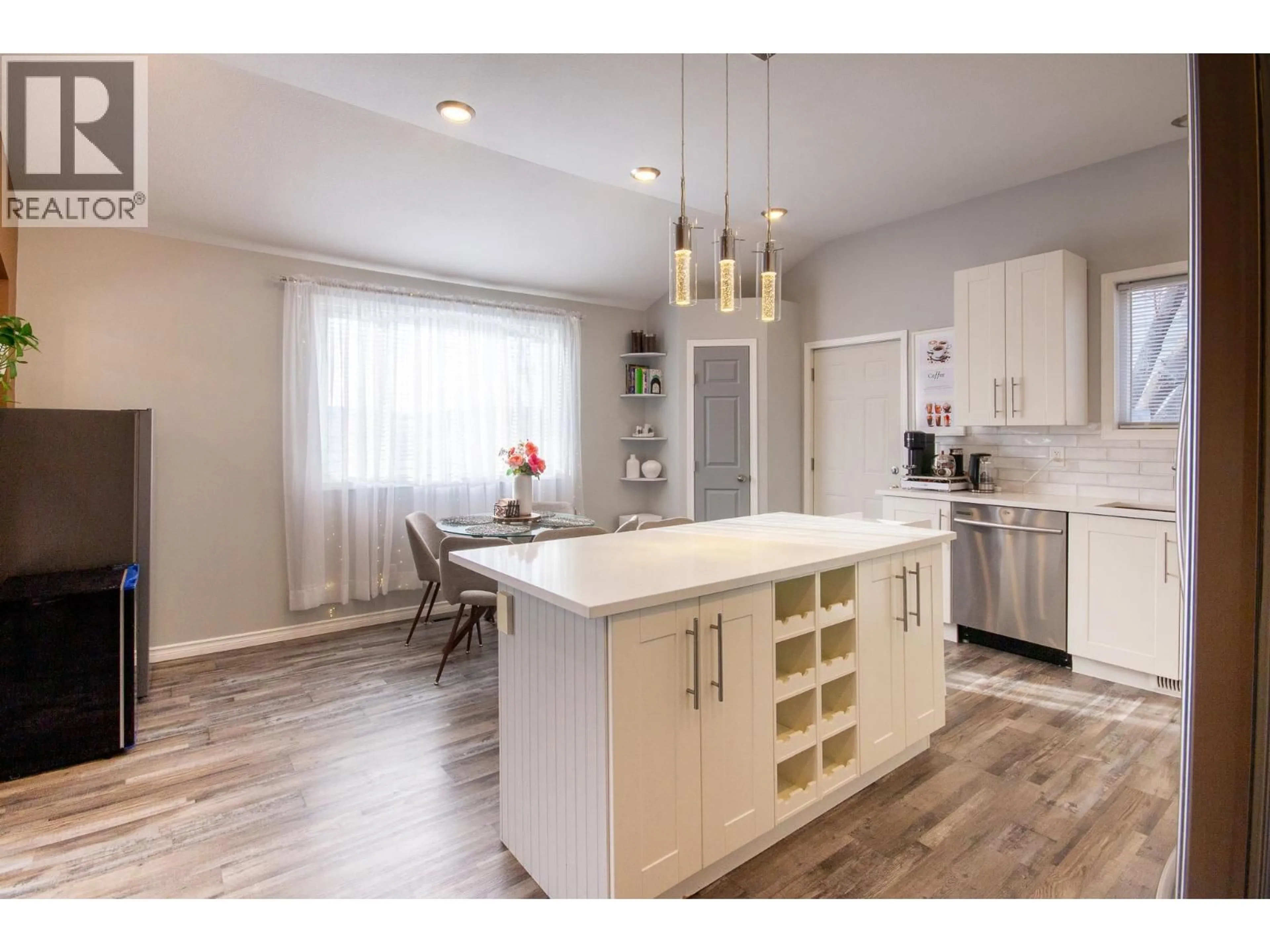 Open concept kitchen, wood/laminate floor for 1500 96 AVENUE, Dawson Creek British Columbia V1G1L6
