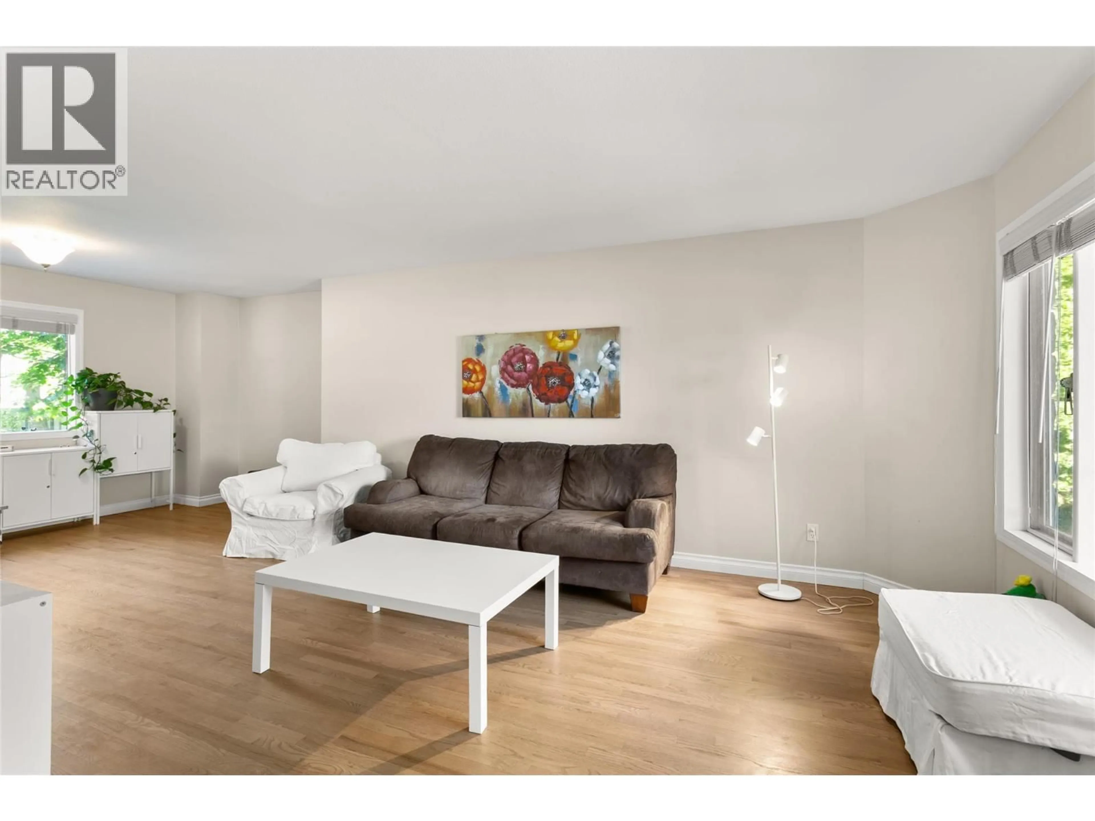Living room with furniture, wood/laminate floor for 515 SARSONS ROAD, Kelowna British Columbia V1W2X3