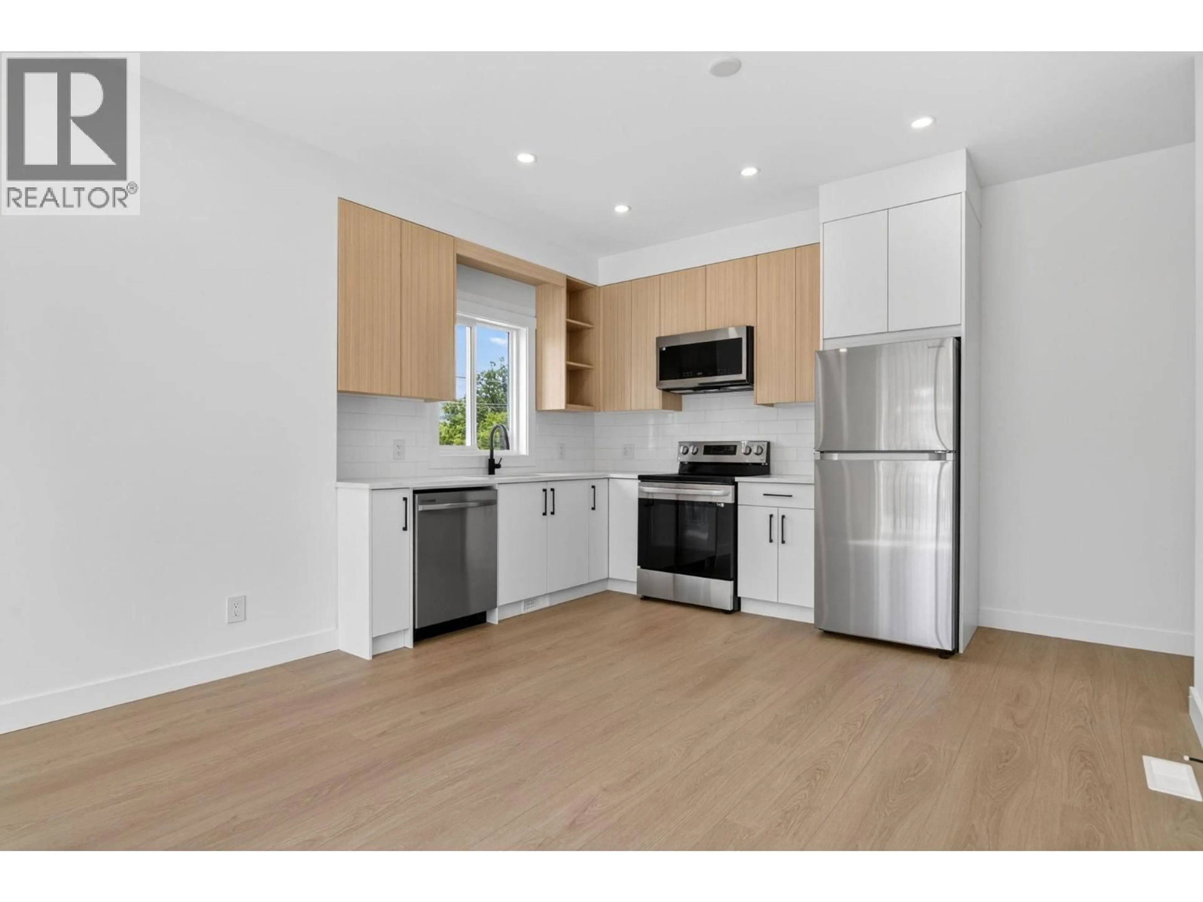 Open concept kitchen, wood/laminate floor for 3109 15TH AVENUE, Vernon British Columbia V1T5G7