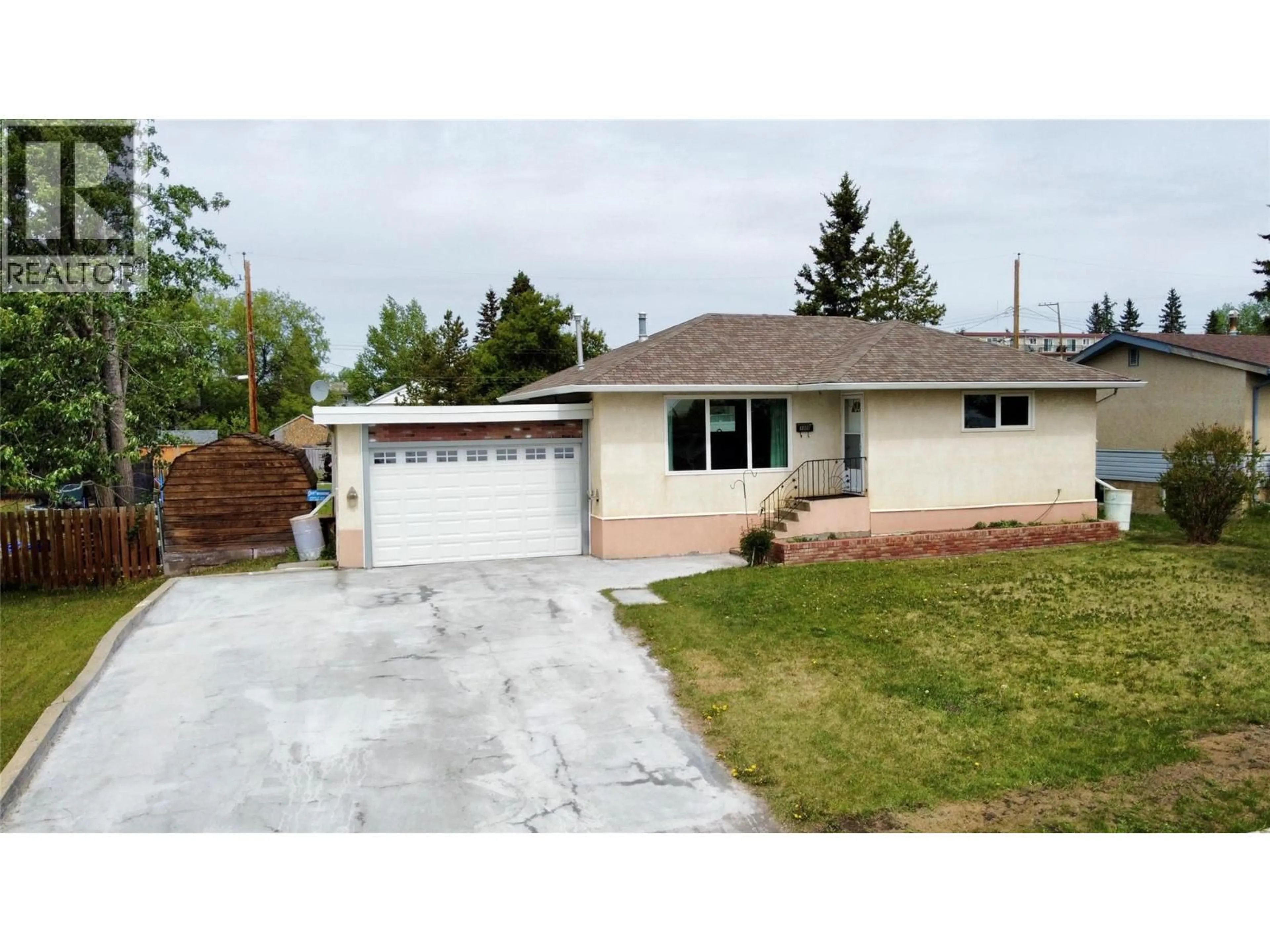 Home with vinyl exterior material, street for 1008 95 AVENUE, Dawson Creek British Columbia V1G1C8