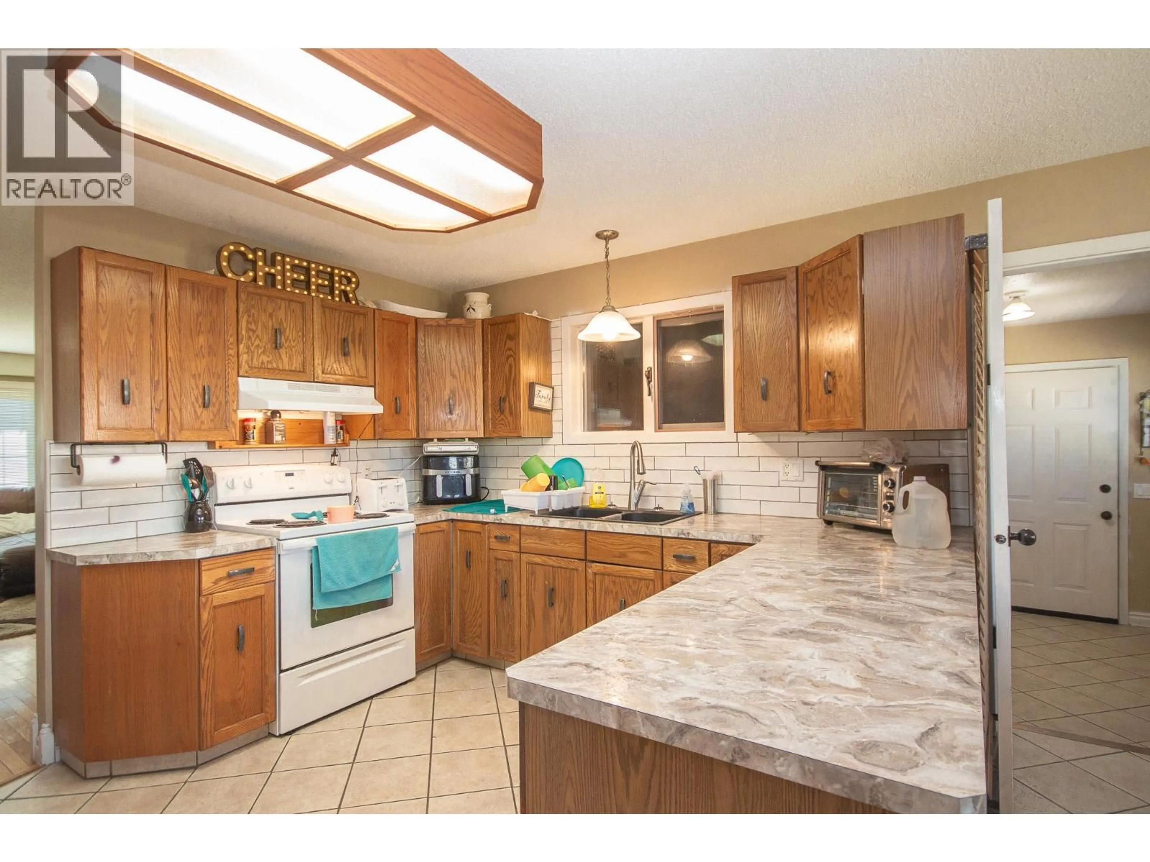 Open concept kitchen, ceramic/tile floor for 1704 CEDARWOOD COURT, Dawson Creek British Columbia V1G4L8