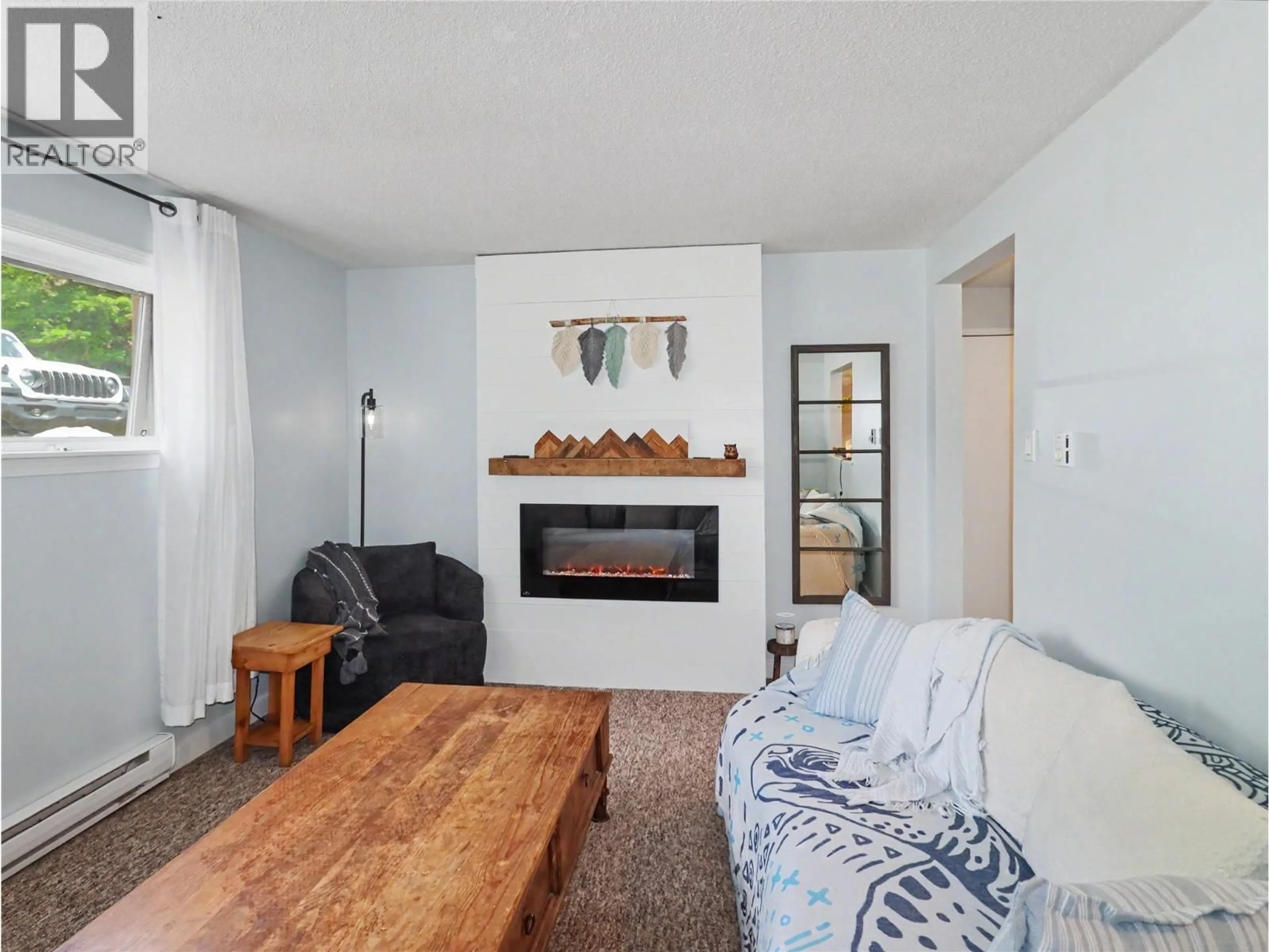 Living room with furniture, wood/laminate floor for 1 - 668 75TH AVENUE, Grand Forks British Columbia V0H1H0