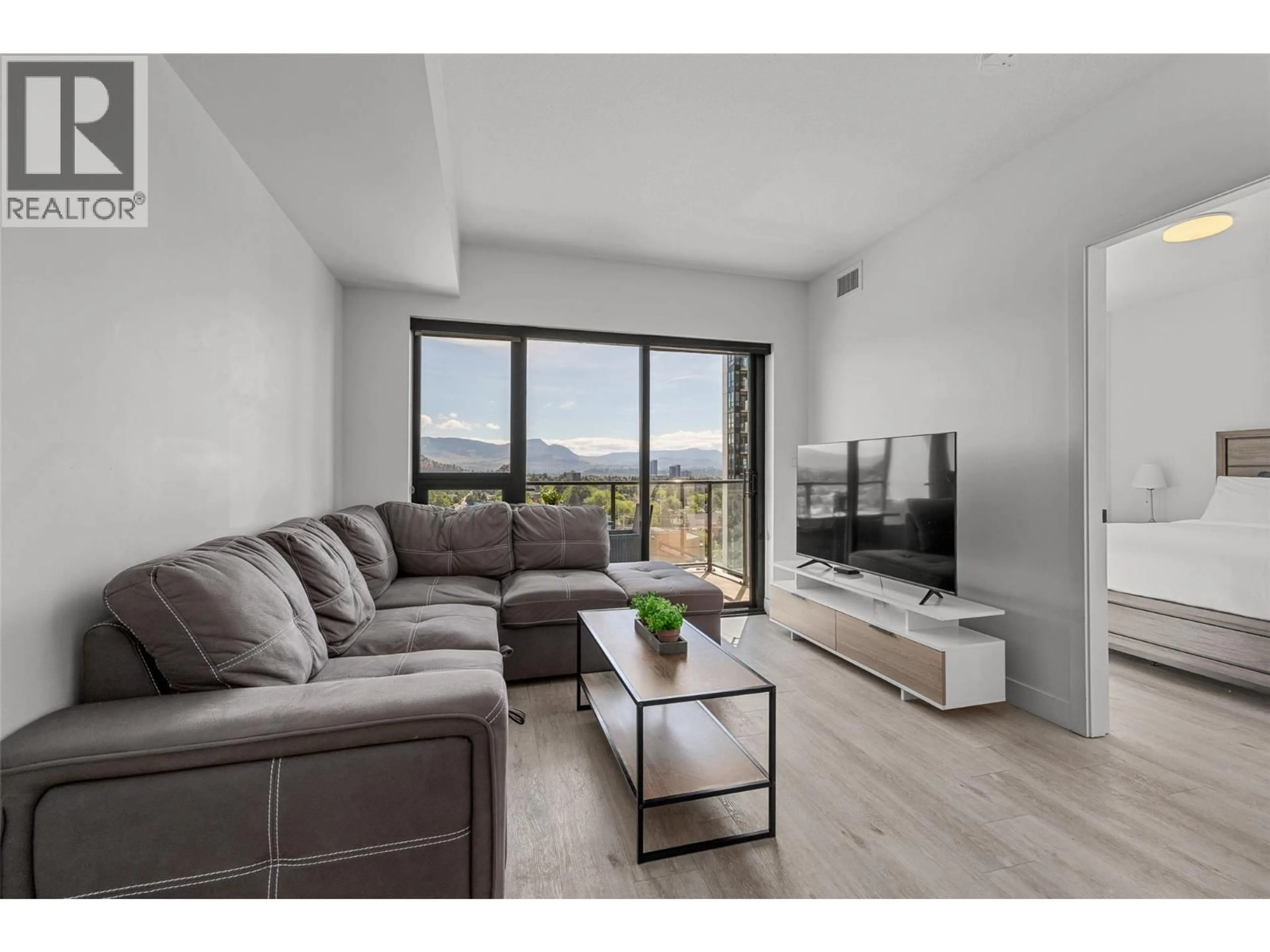 Living room with furniture, wood/laminate floor for 1201 - 1471 ST PAUL STREET, Kelowna British Columbia V1Y2E6