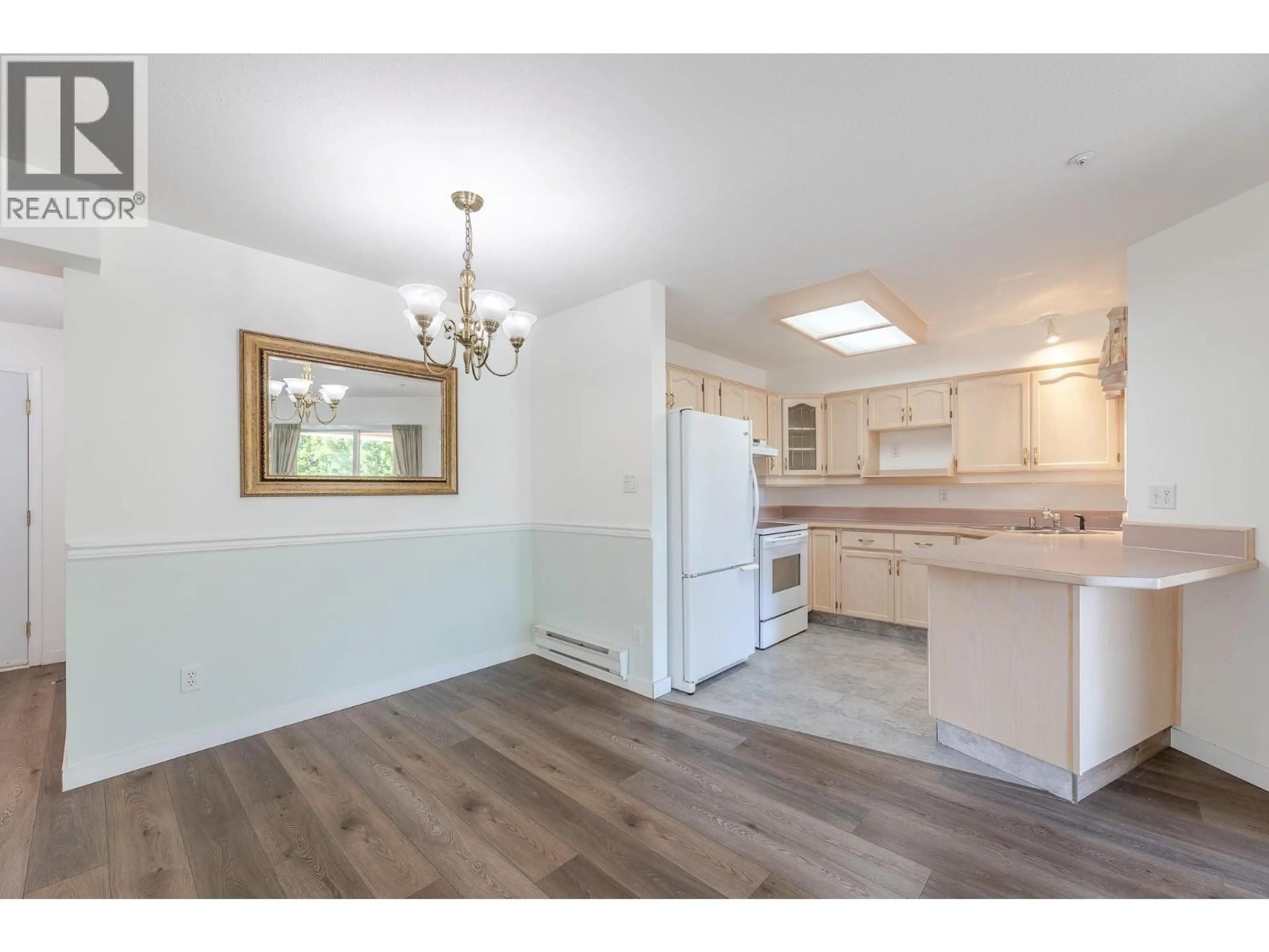 Open concept kitchen, wood/laminate floor for 302 - 1750 ATKINSON STREET, Penticton British Columbia V2A7M6