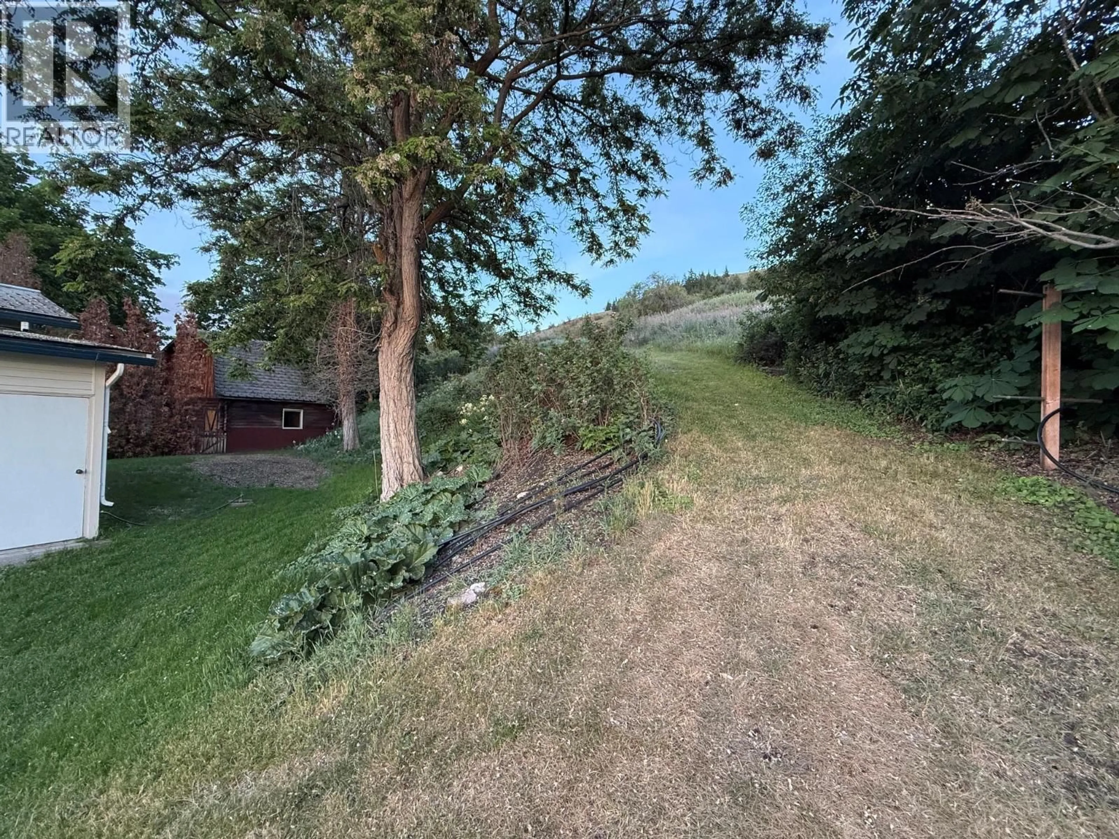 A pic from outside/outdoor area/front of a property/back of a property/a pic from drone, forest/trees view for 825 MISSION ROAD, Vernon British Columbia V1H1G2