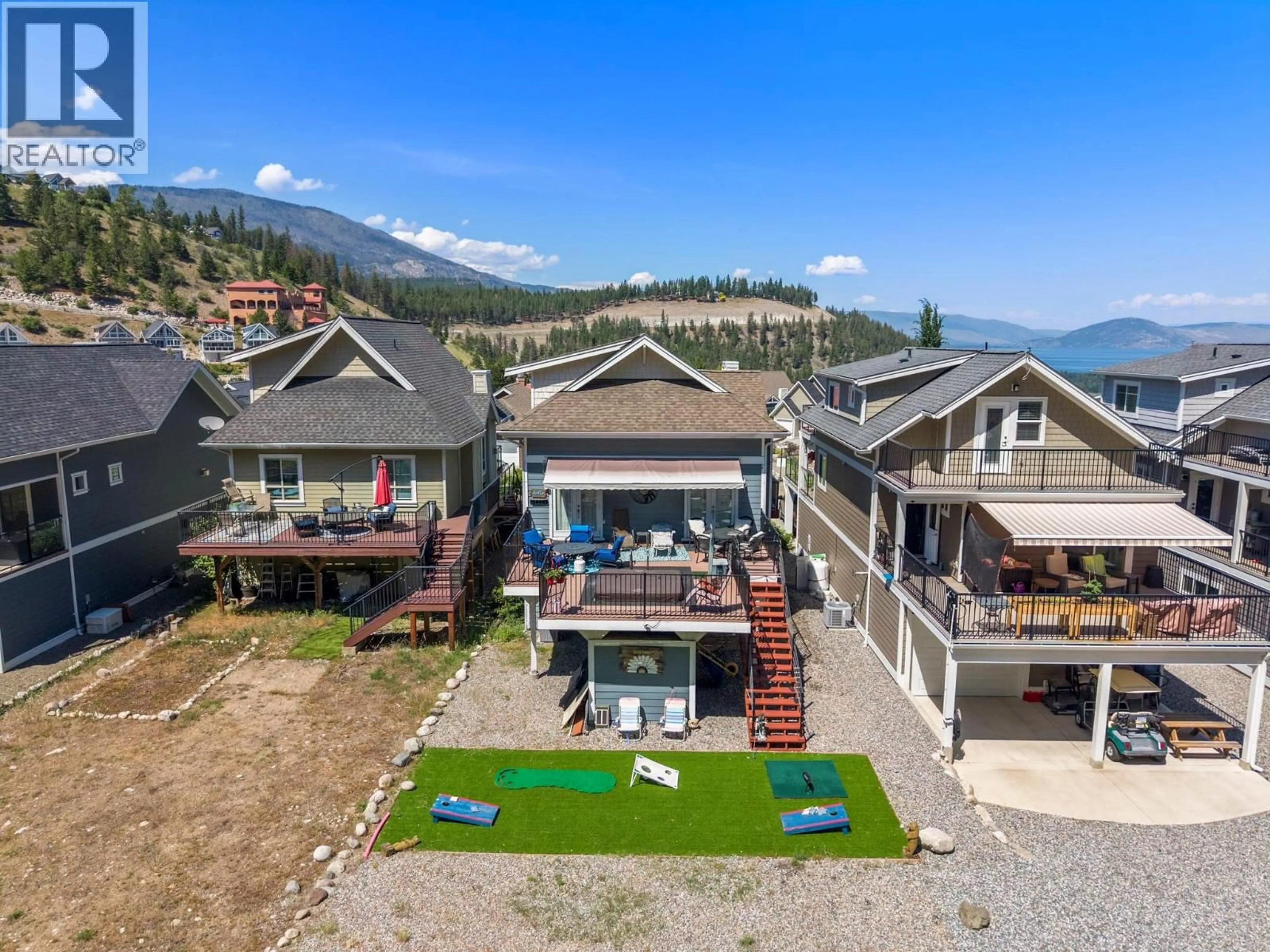 A pic from outside/outdoor area/front of a property/back of a property/a pic from drone, mountain view for 307 - 6816 MADRID WAY, Kelowna British Columbia V1Z3R8