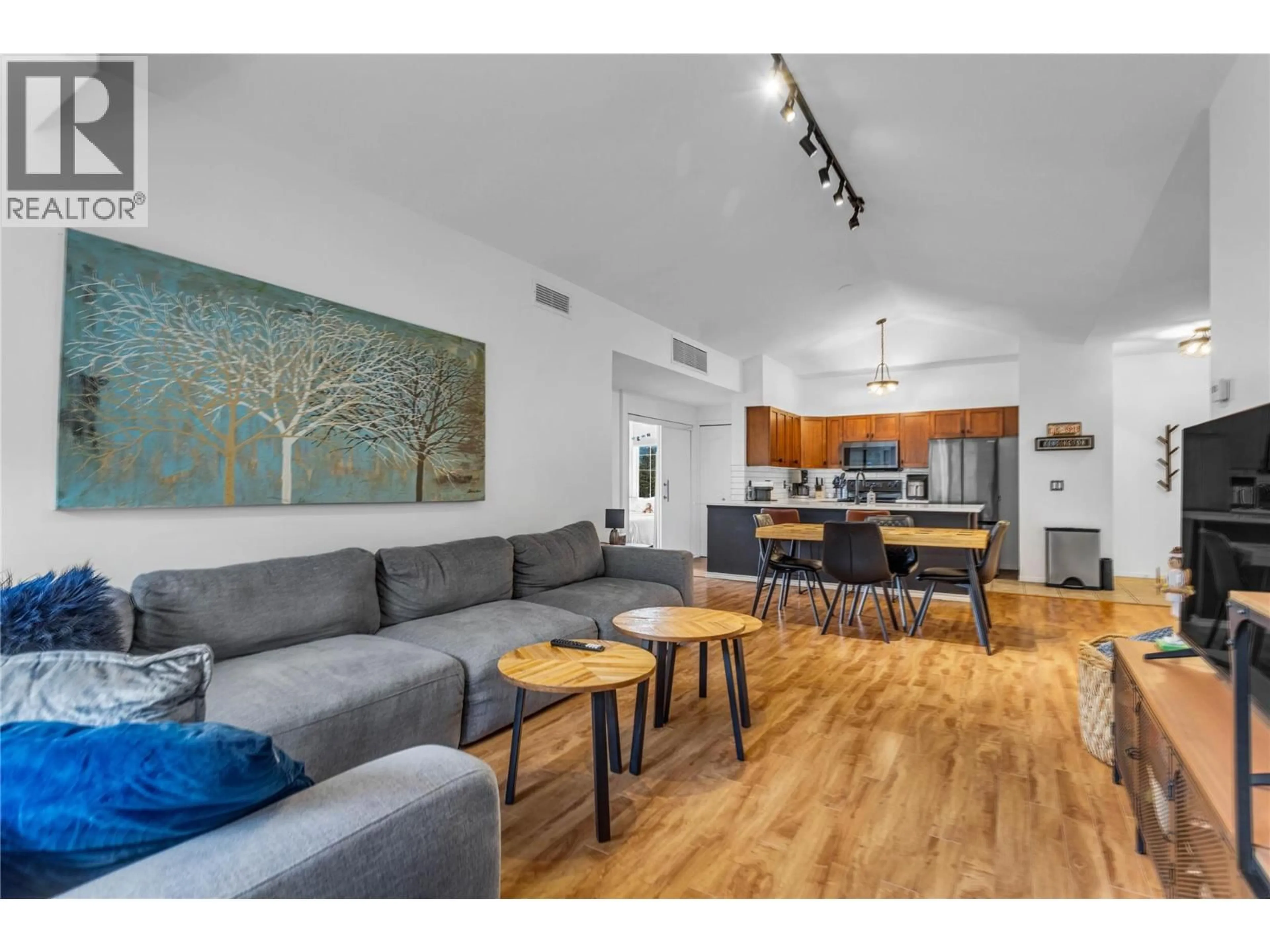Living room with furniture, wood/laminate floor for 1407 - 3168 VIA CENTRALE ROAD, Kelowna British Columbia V1V2R6