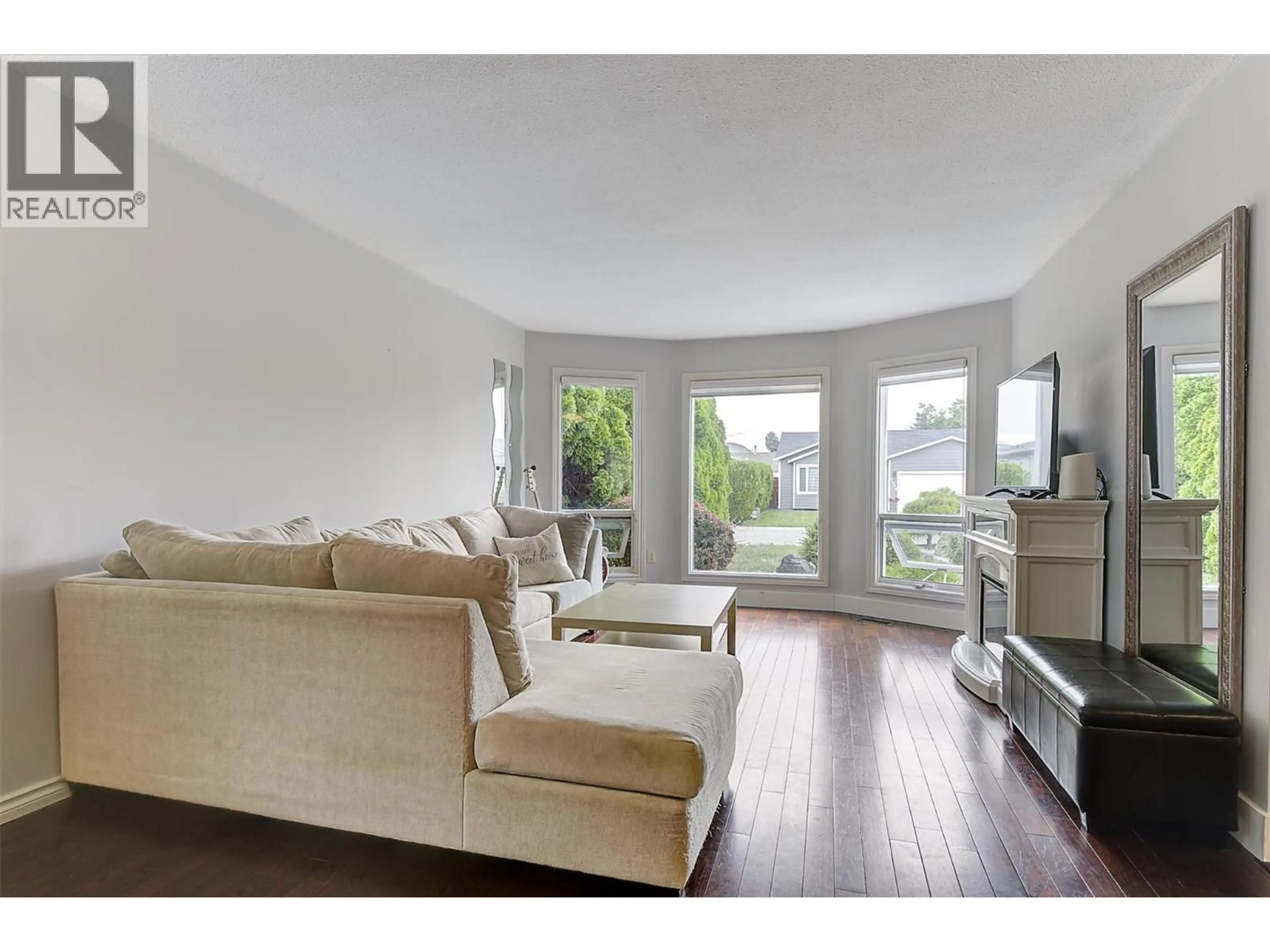 Living room with furniture, wood/laminate floor for 3430 SILVERBERRY ROAD, Kelowna British Columbia V1W3V5