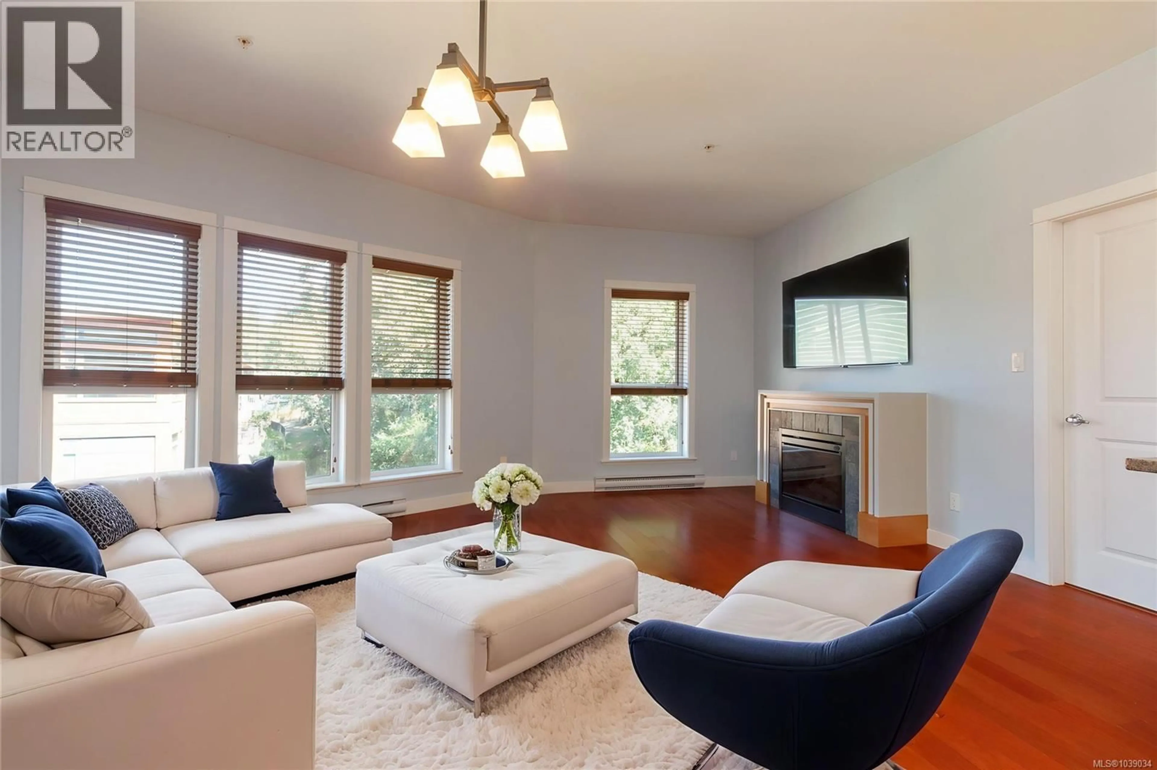 Living room with furniture, wood/laminate floor for 407 - 101 NURSERY HILL DRIVE, View Royal British Columbia V9B1H5