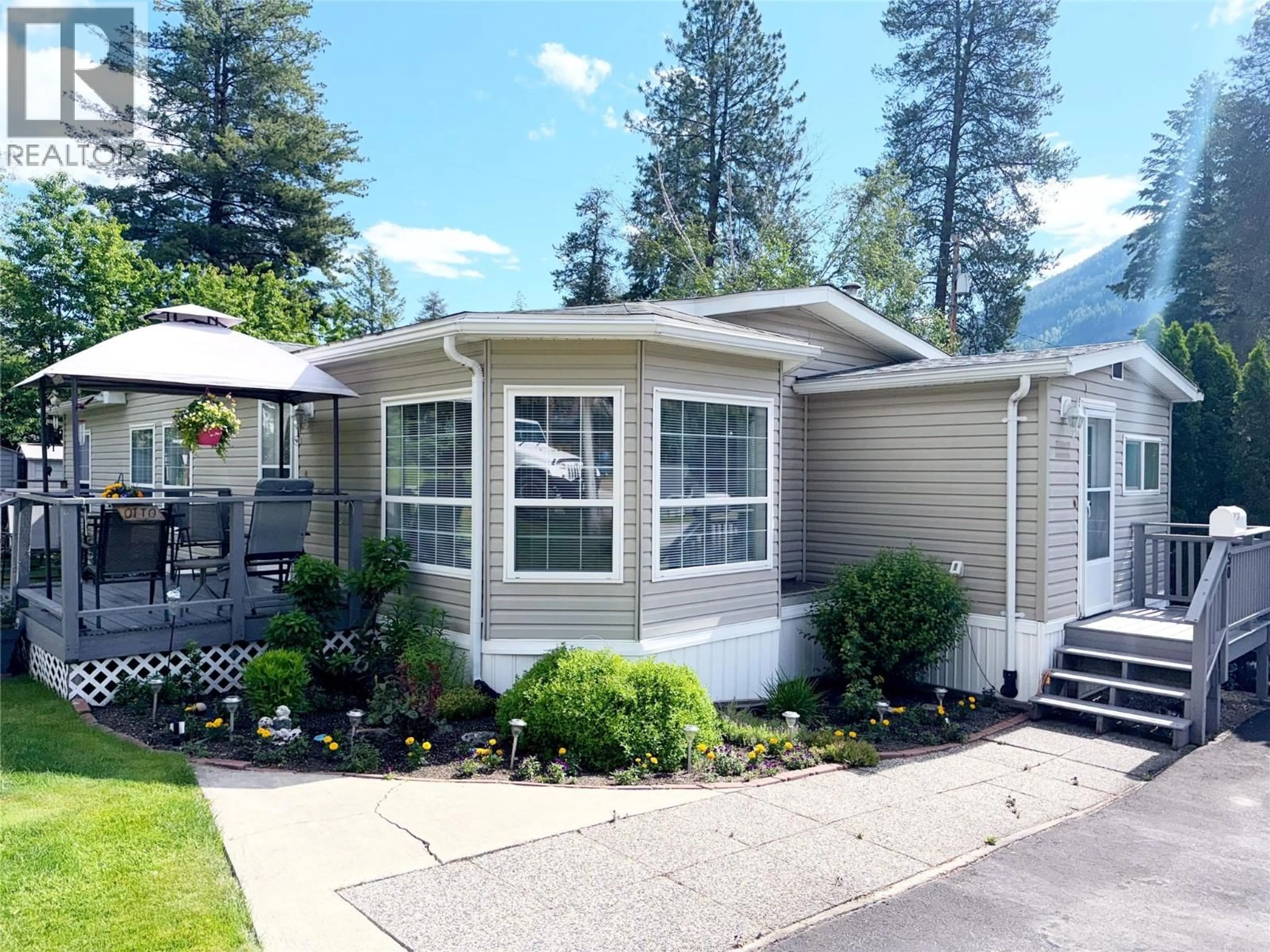 Home with vinyl exterior material, street for 50 - 500 16TH AVENUE, Genelle British Columbia V0G1G0