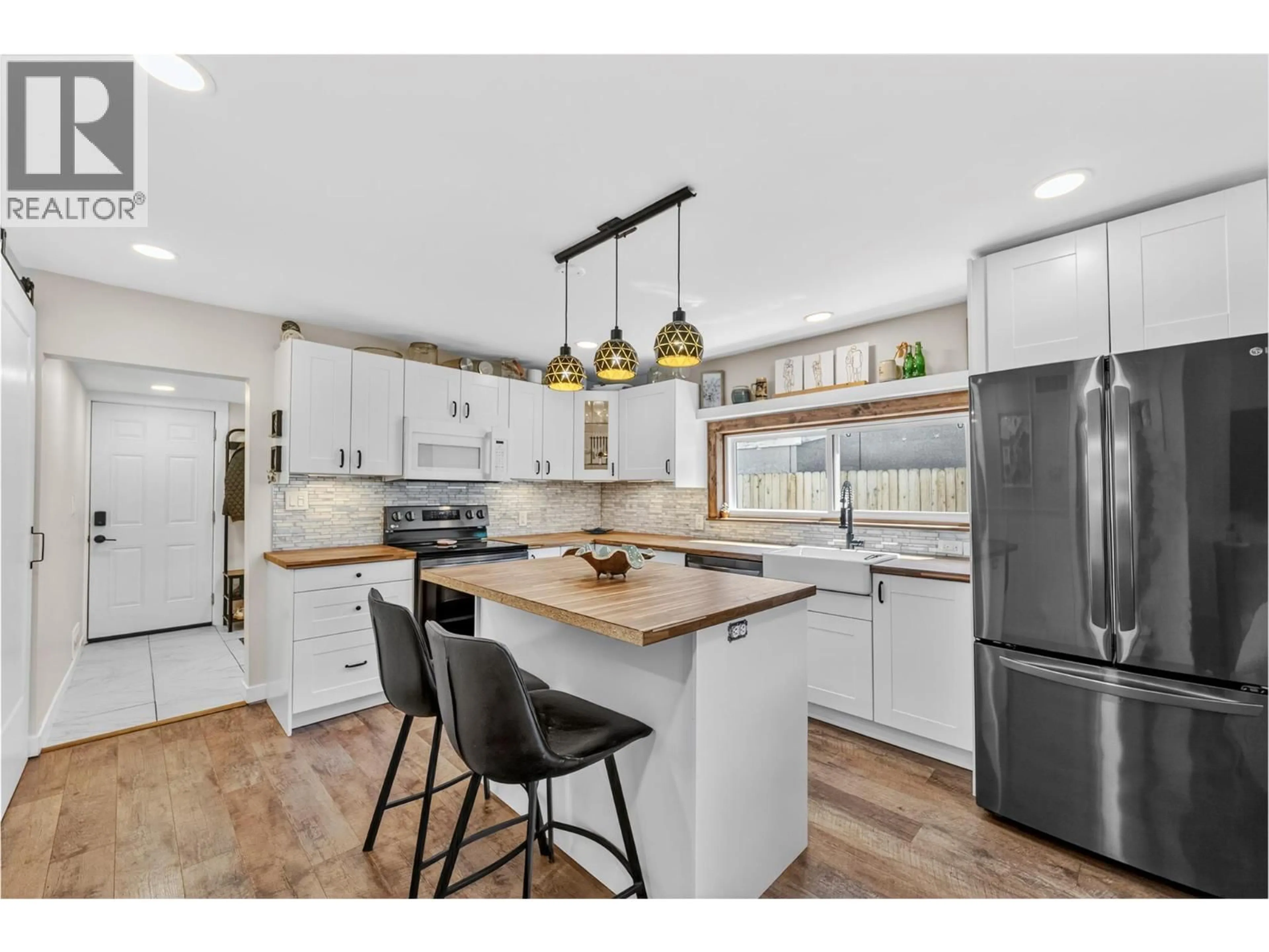Open concept kitchen, wood/laminate floor for 1681 CANFORD AVENUE, Merritt British Columbia V1K1B8