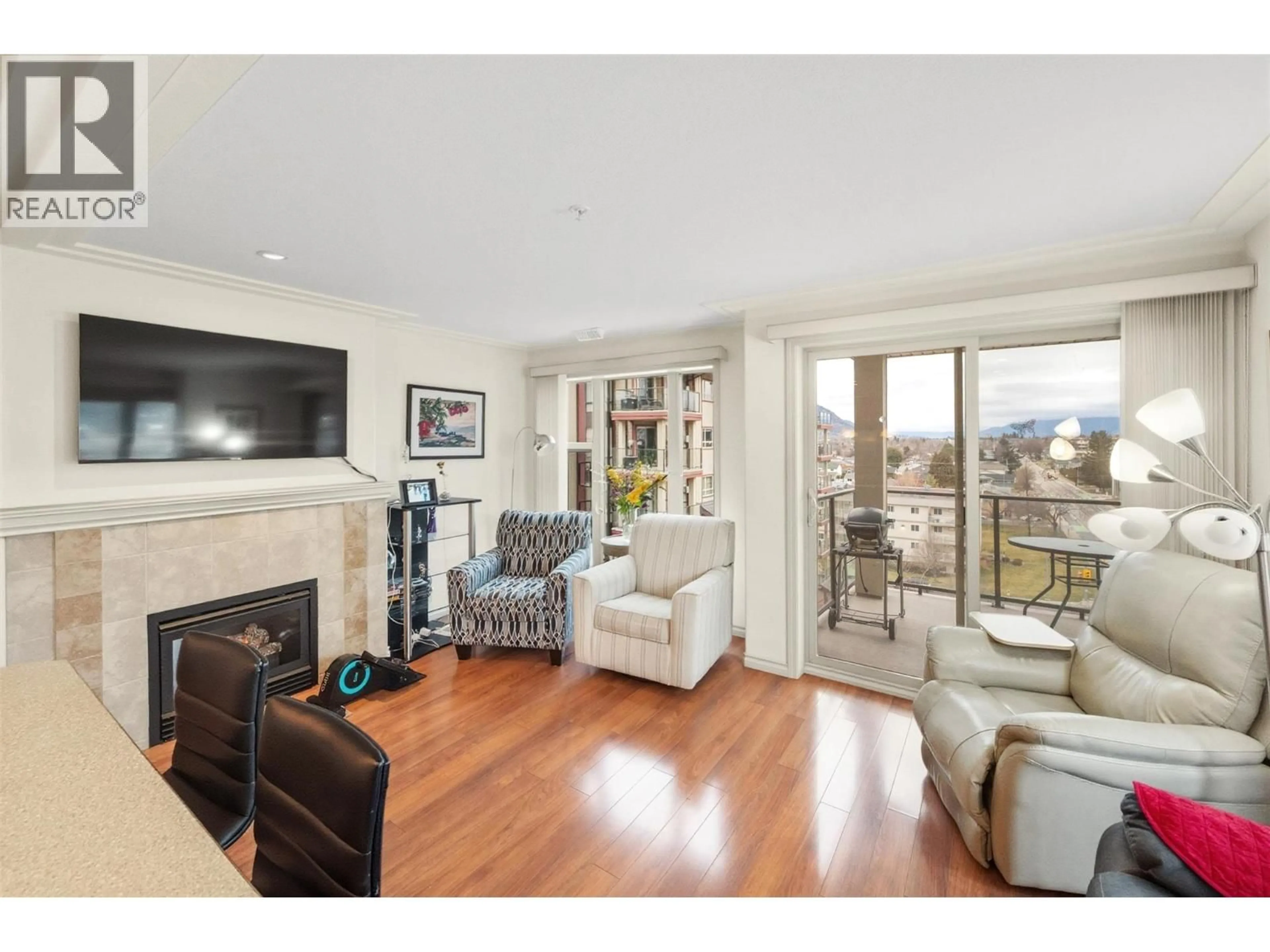Living room with furniture, wood/laminate floor for 702 - 2125 ATKINSON STREET, Penticton British Columbia V2A9E6
