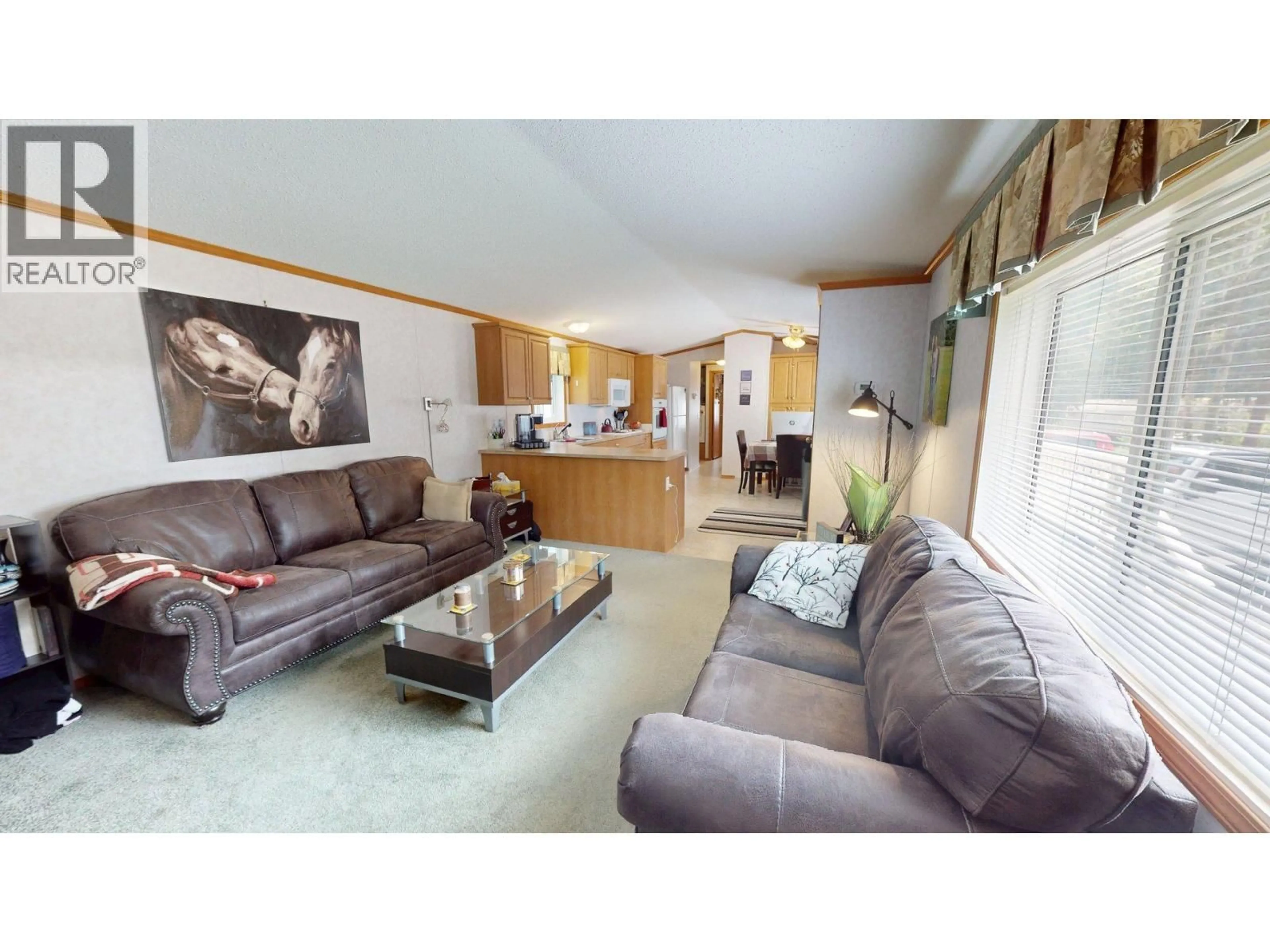 Living room with furniture, wood/laminate floor for 82B - 500 16TH AVENUE, Genelle British Columbia V0G1G0