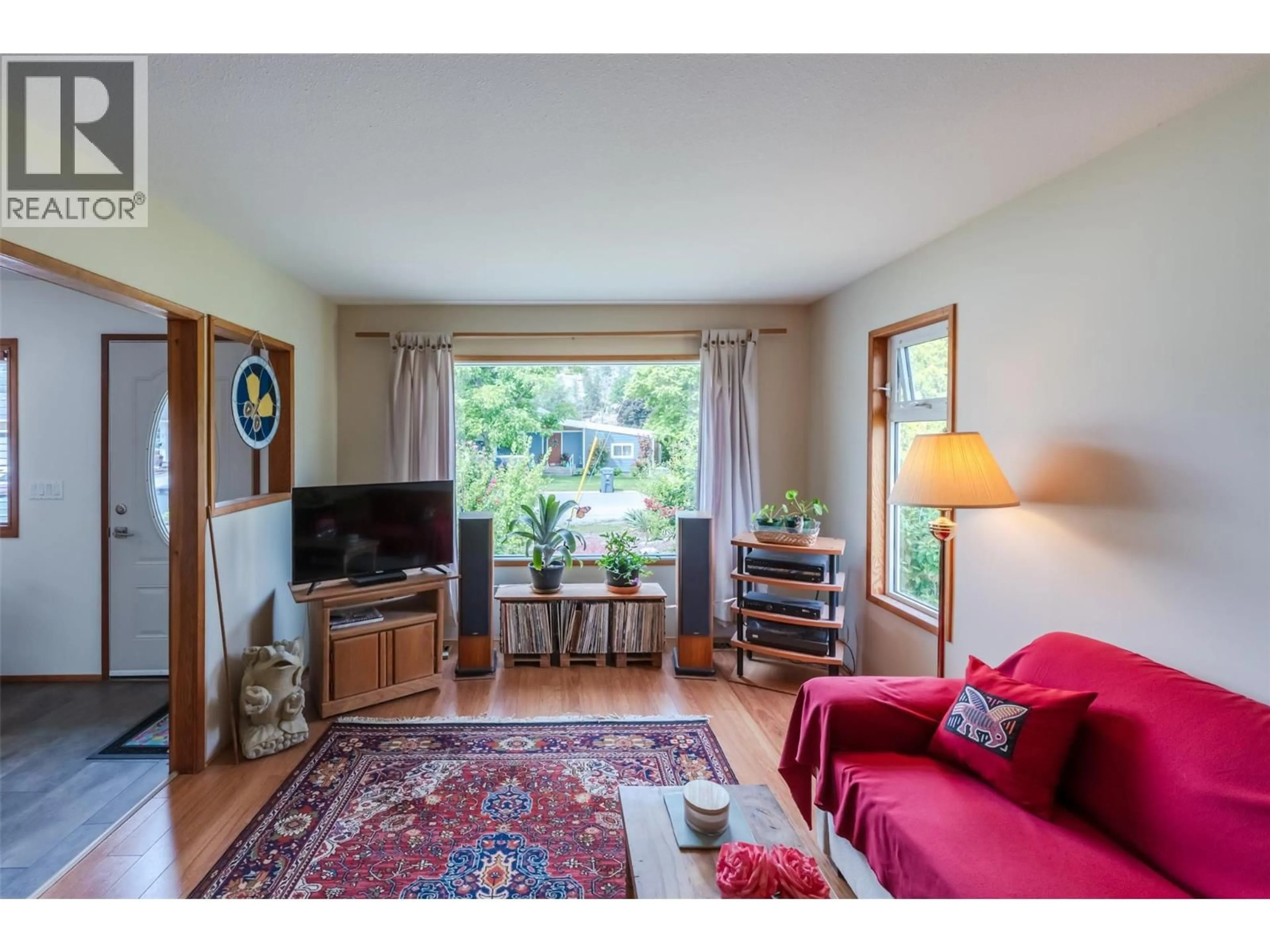 Living room with furniture, wood/laminate floor for 11819 GRANT AVENUE, Summerland British Columbia V0H1Z8