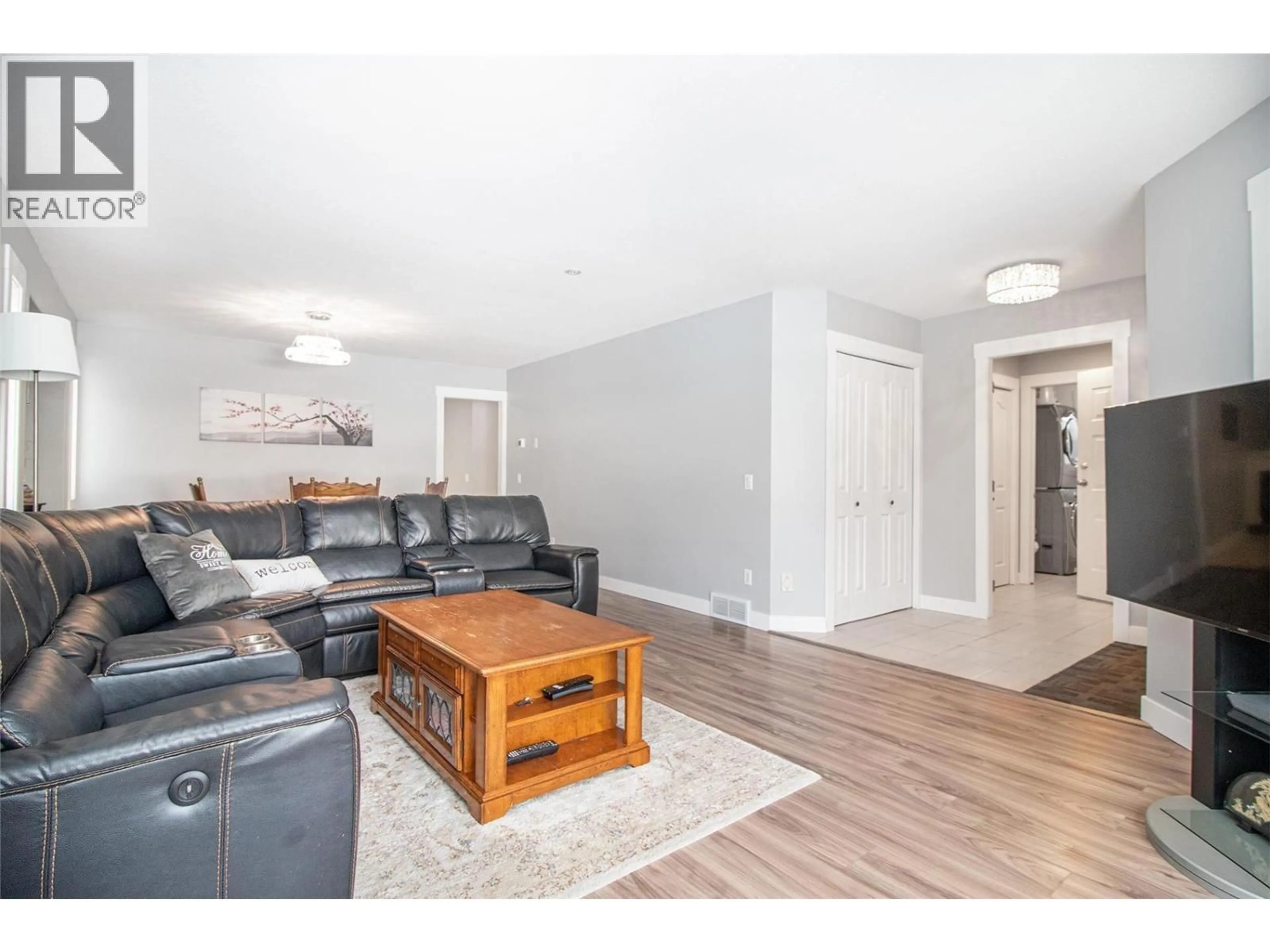 Living room with furniture, wood/laminate floor for 1325 BOTHE ROAD, Kelowna British Columbia V1W3C1
