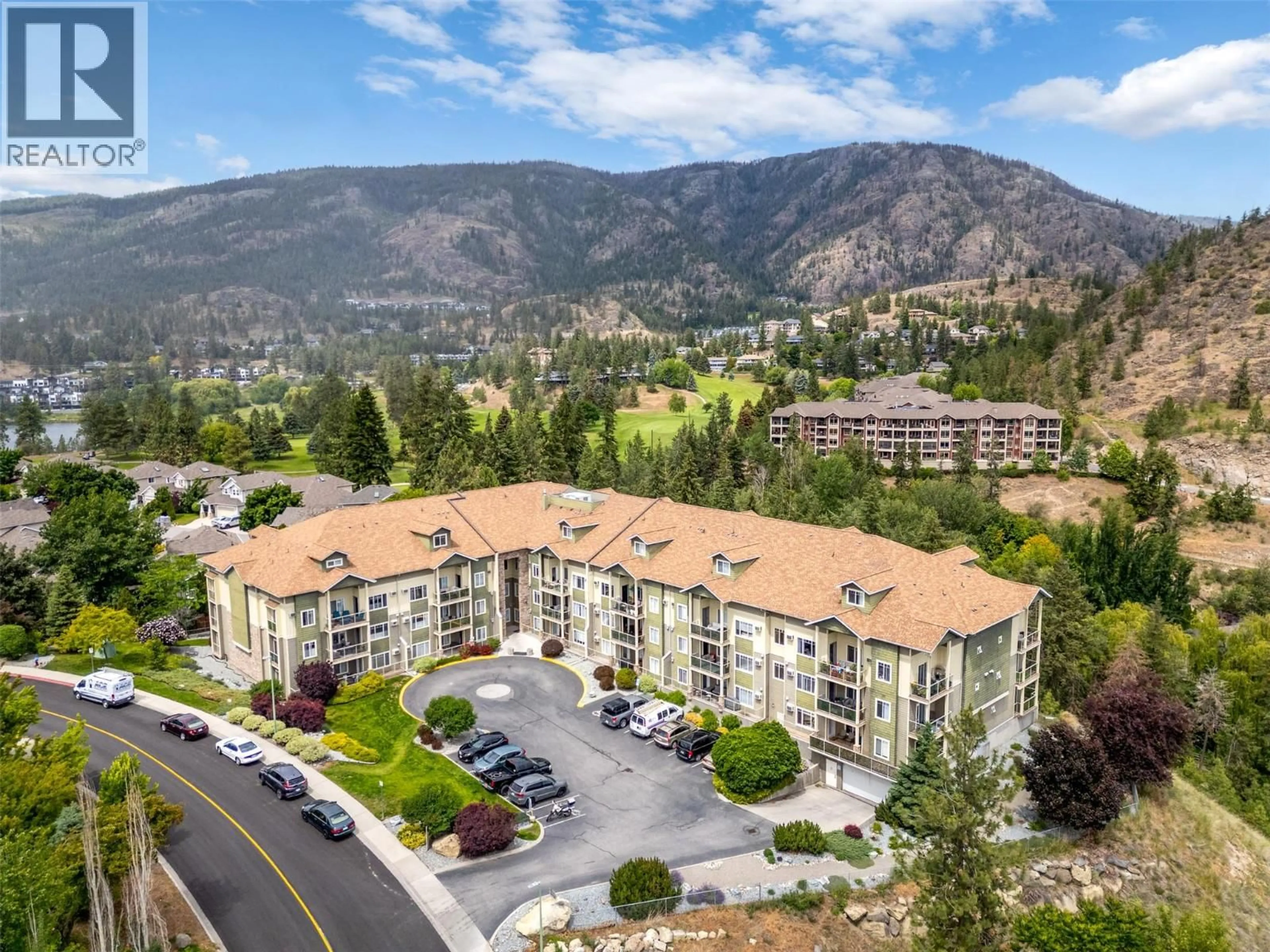 A pic from outside/outdoor area/front of a property/back of a property/a pic from drone, mountain view for 105 - 2120 SHANNON RIDGE DRIVE, West Kelowna British Columbia V4T2Z3