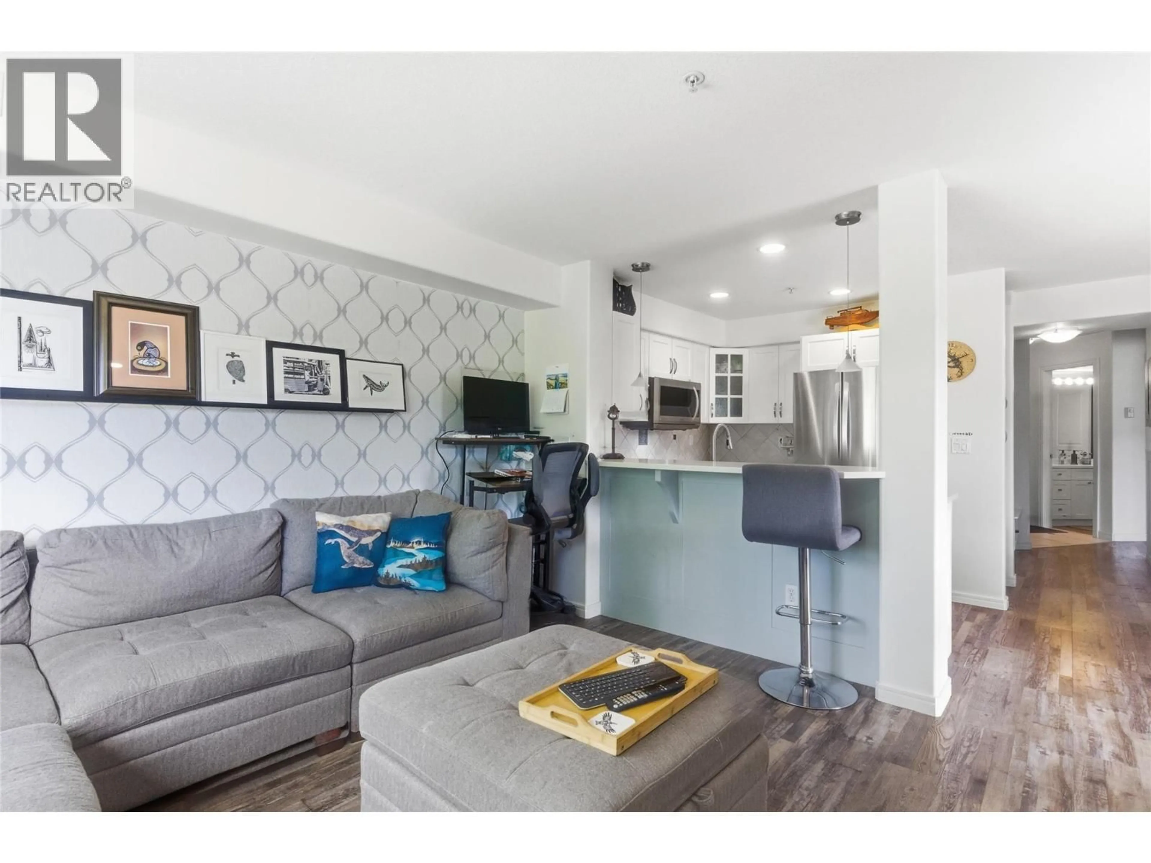 Living room with furniture, wood/laminate floor for 310 - 950 LORNE STREET, Kamloops British Columbia V2C1W9