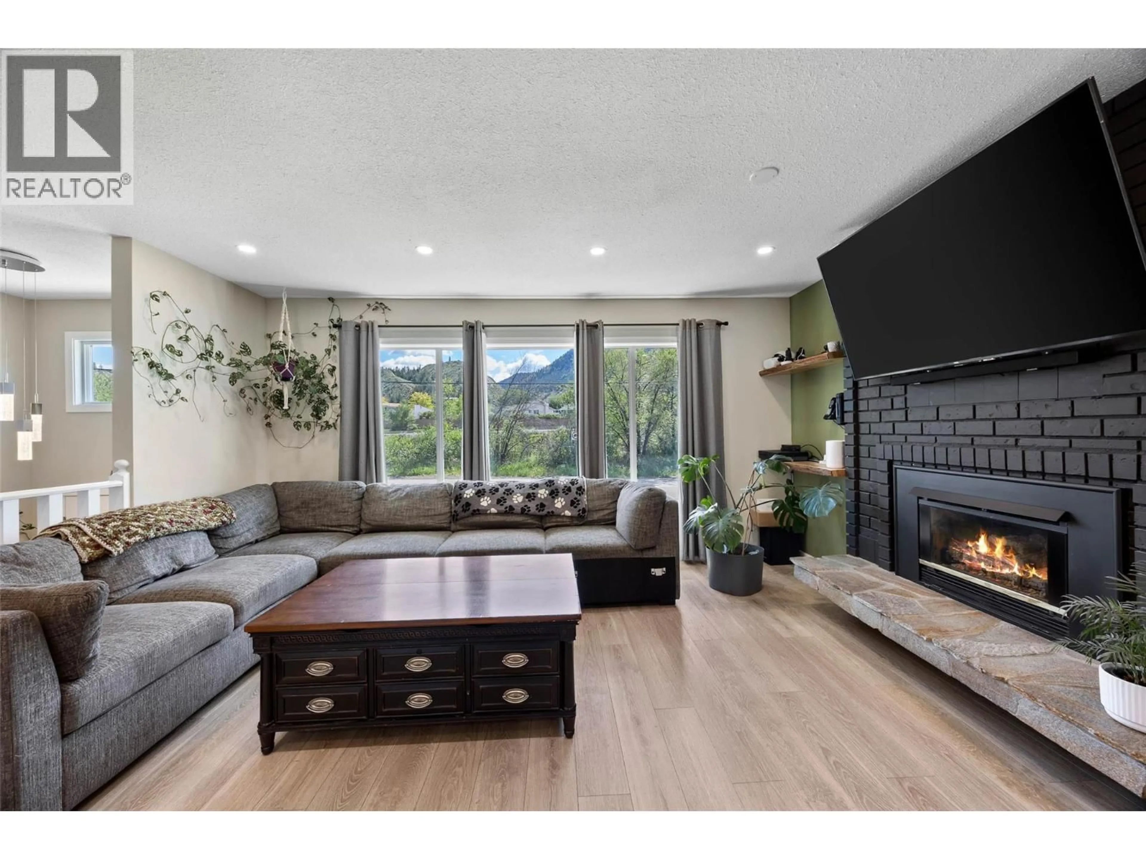 Living room with furniture, wood/laminate floor for 5376 KIPP ROAD, Kamloops British Columbia V2C6H7