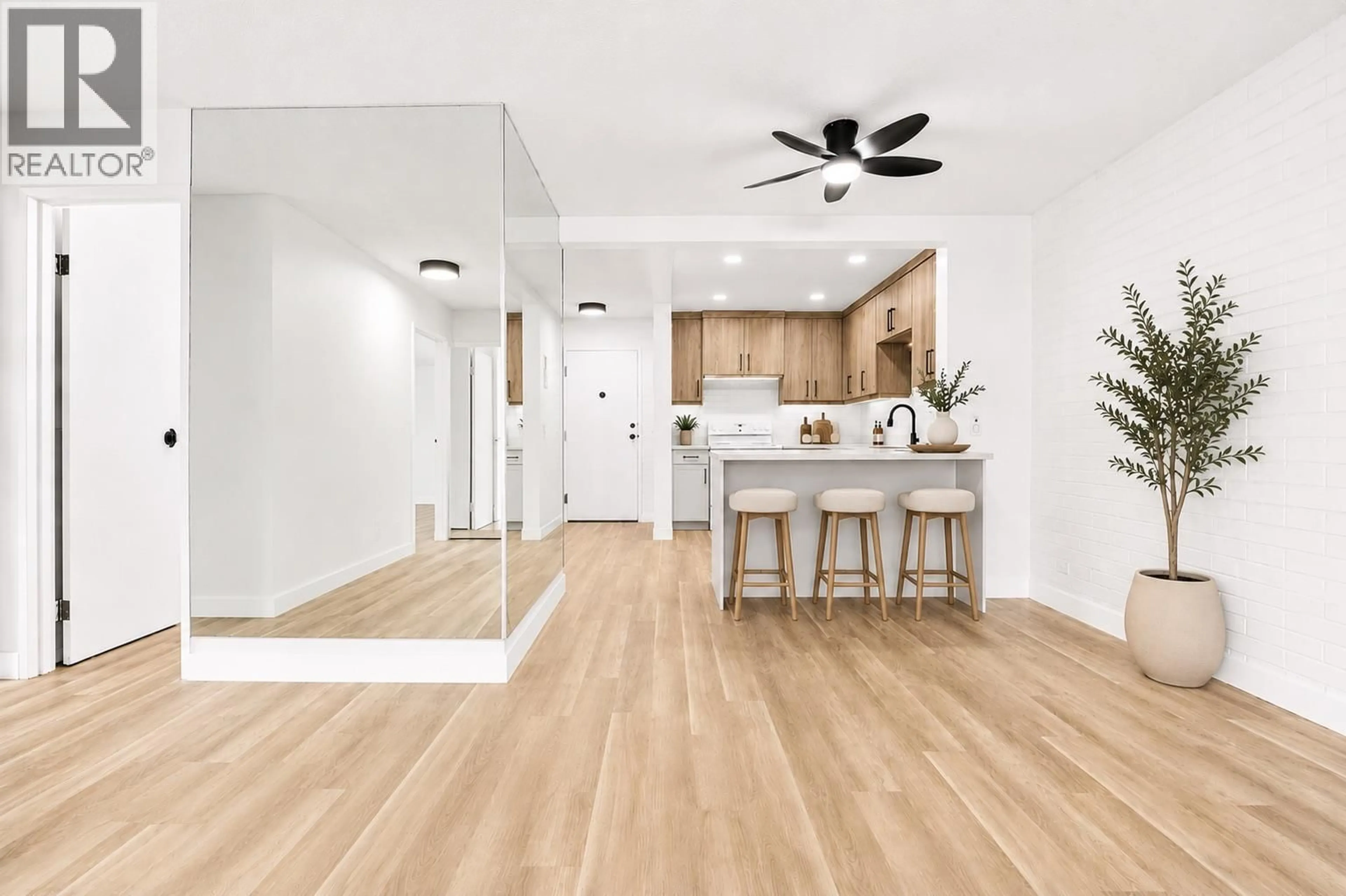 Open concept kitchen, wood/laminate floor for 104 - 1915 PACIFIC COURT, Kelowna British Columbia V1Y8B3