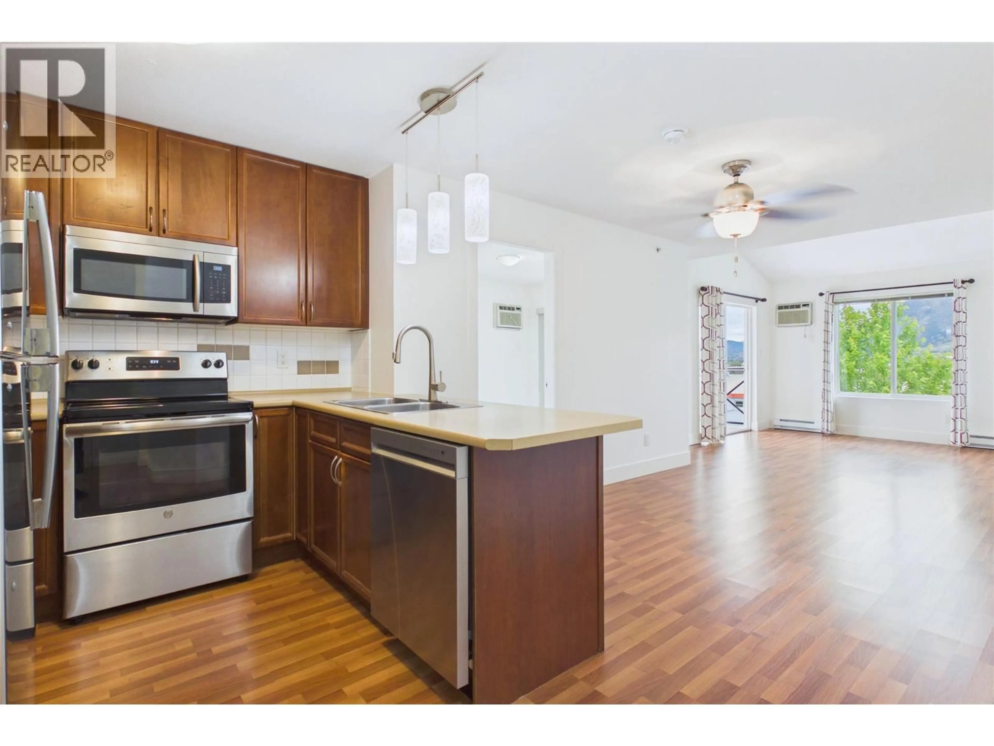 Open concept kitchen, wood/laminate floor for 404 - 256 HASTINGS AVENUE, Penticton British Columbia V2A2V6