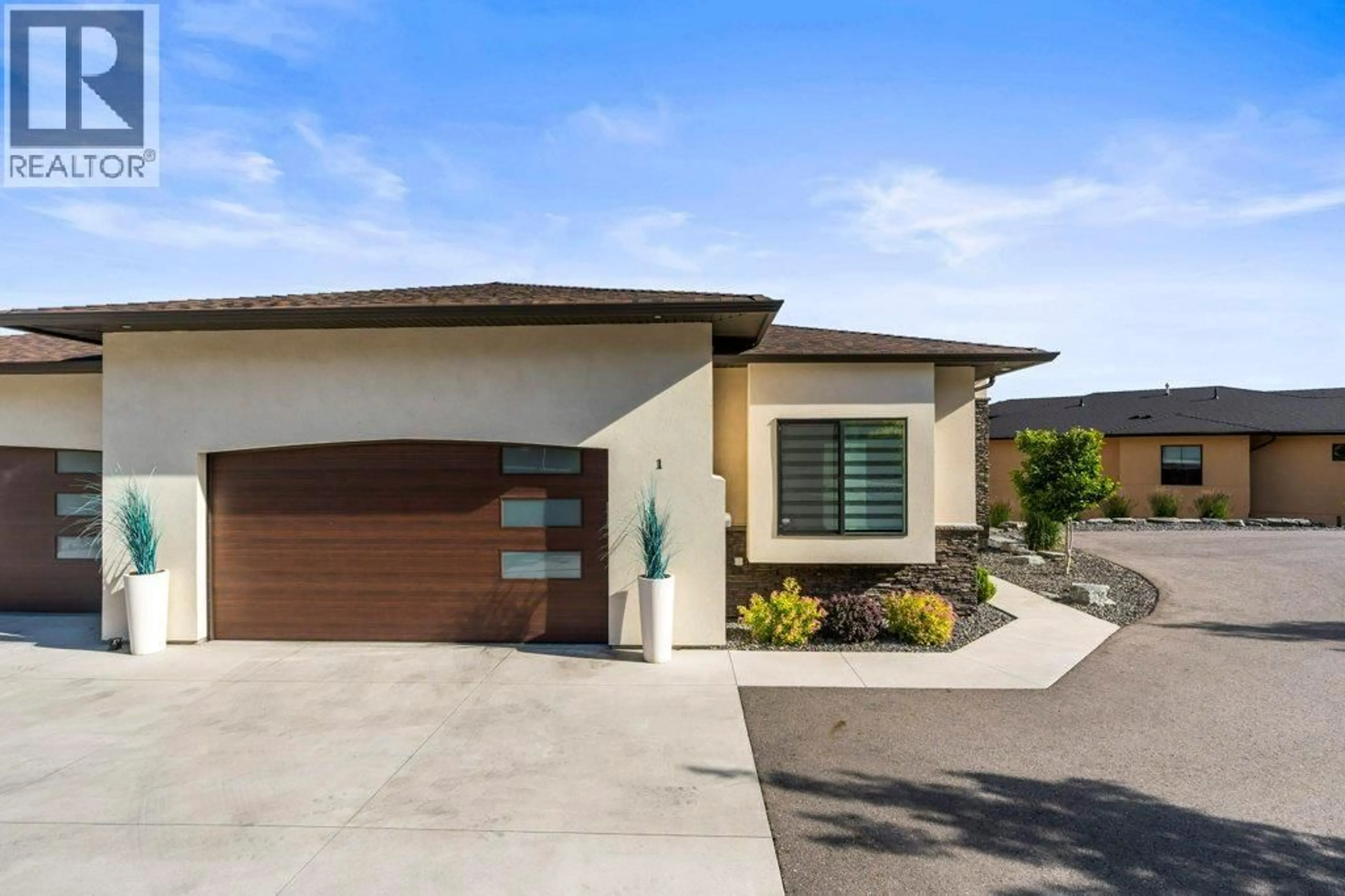 Home with vinyl exterior material, street for 1 - 7716 OKANAGAN HILLS BOULEVARD, Vernon British Columbia V1H1Z9