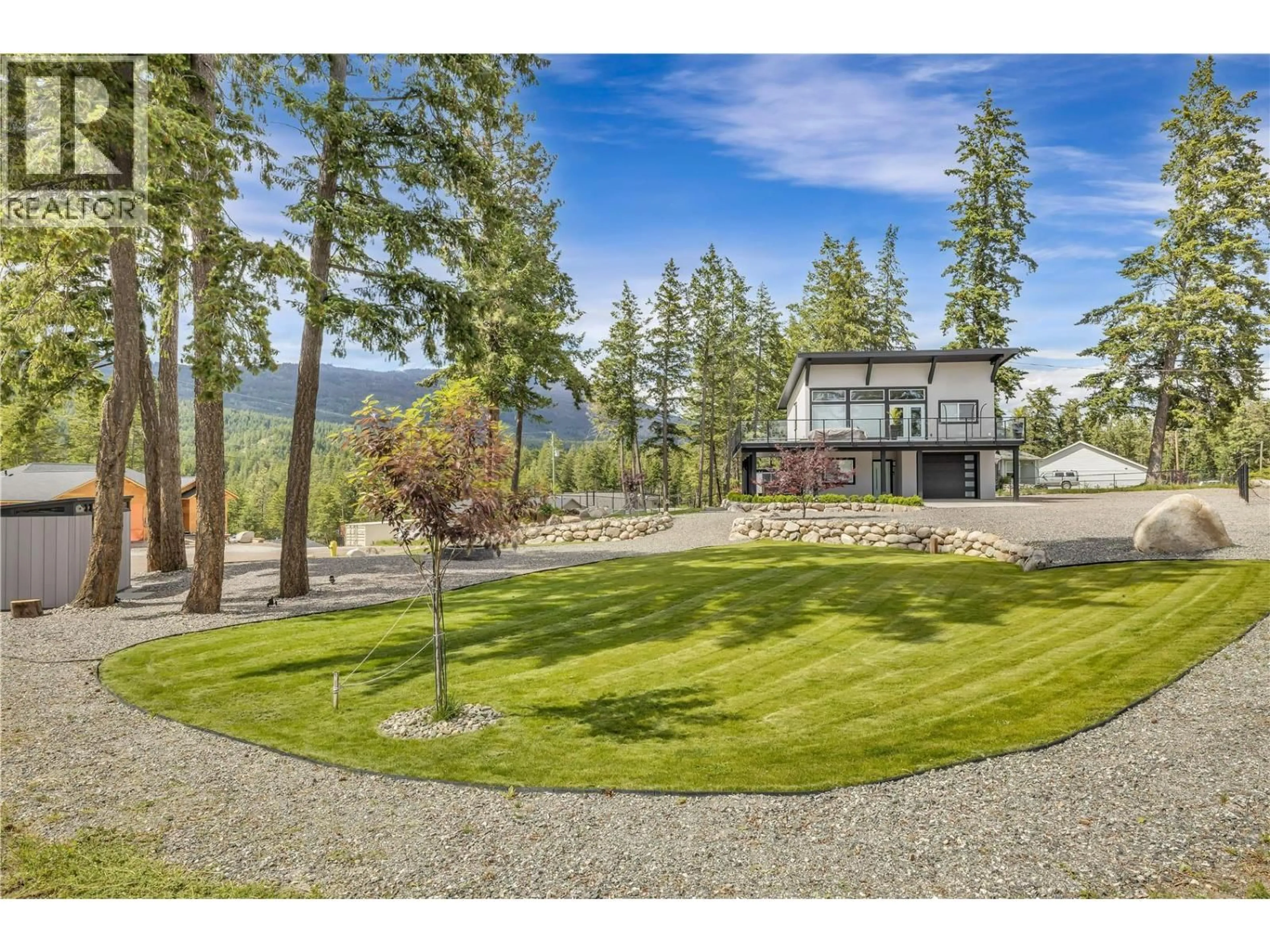 A pic from outside/outdoor area/front of a property/back of a property/a pic from drone, water/lake/river/ocean view for 7210 DUNWATERS ROAD, Kelowna British Columbia V1Z3W5