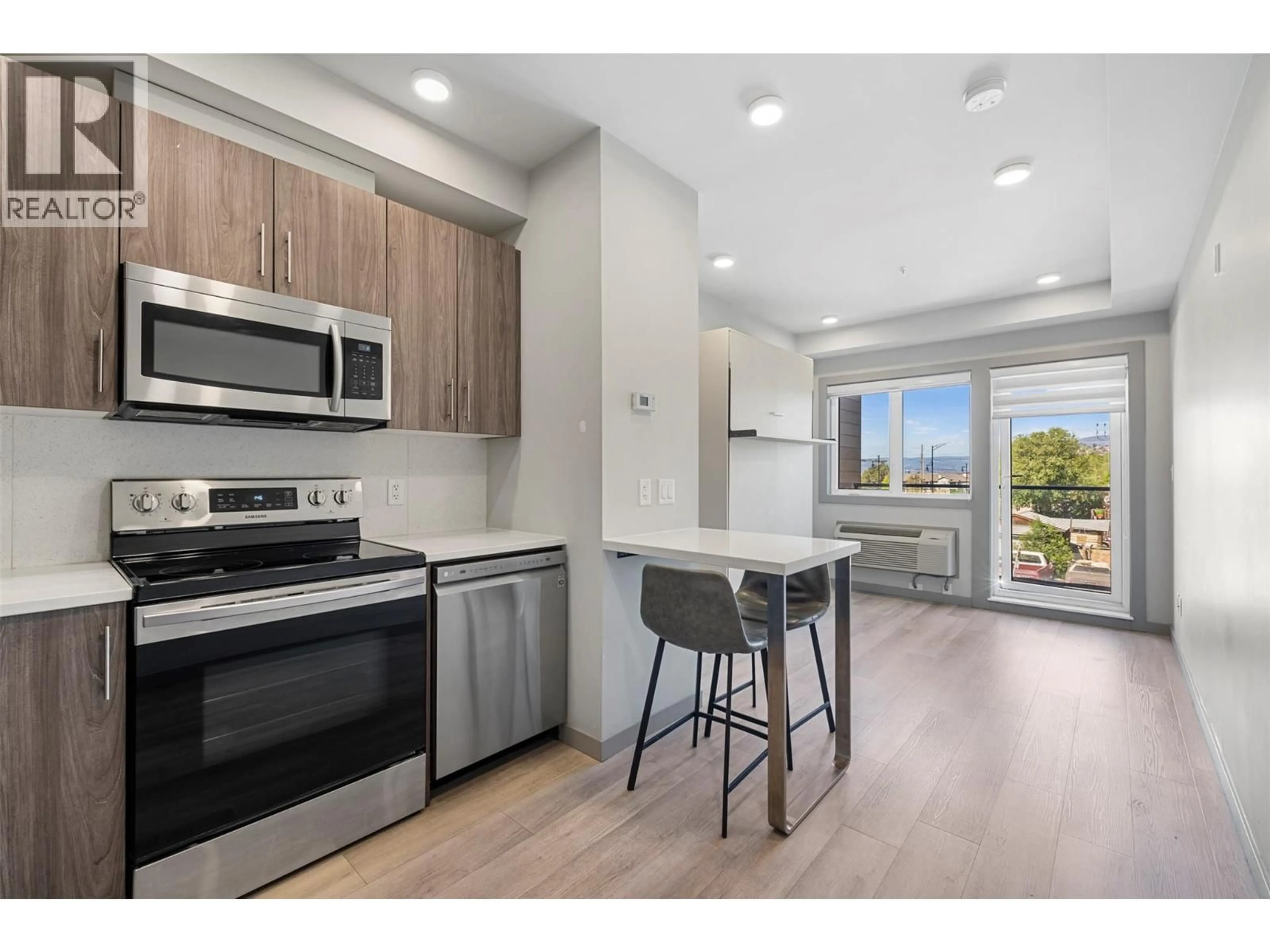 Open concept kitchen, wood/laminate floor for 201 - 345 DOUGALL ROAD NORTH, Kelowna British Columbia V1X0A8