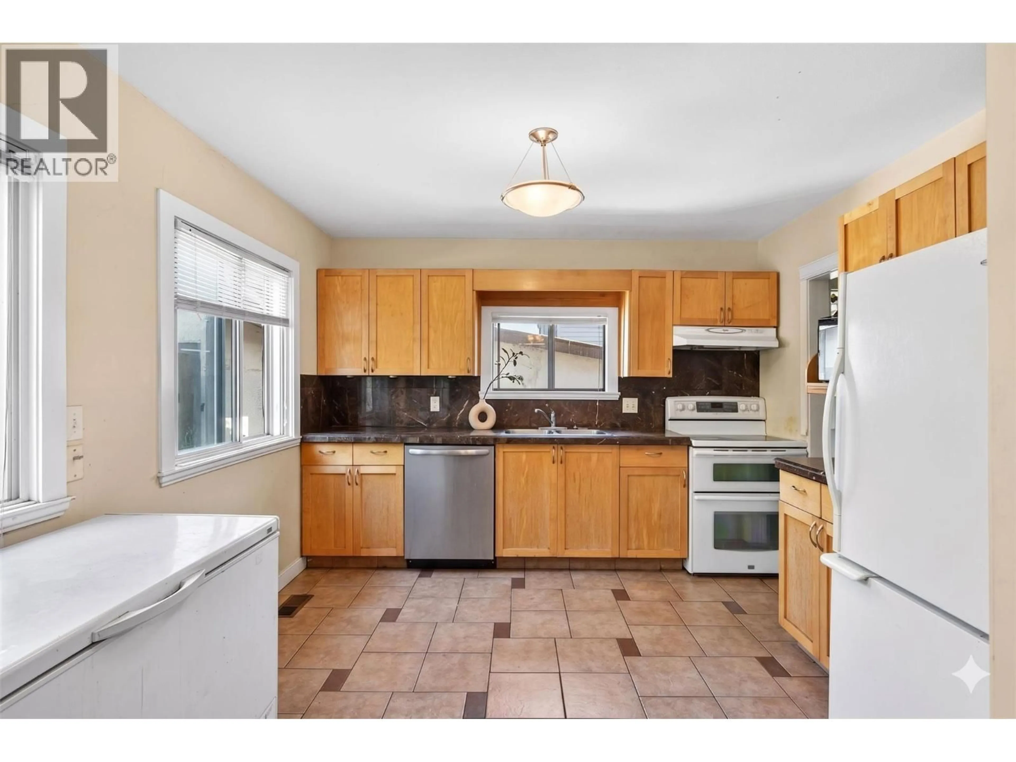 Standard kitchen, ceramic/tile floor for 2435 RICHTER STREET, Kelowna British Columbia V1Y2P5