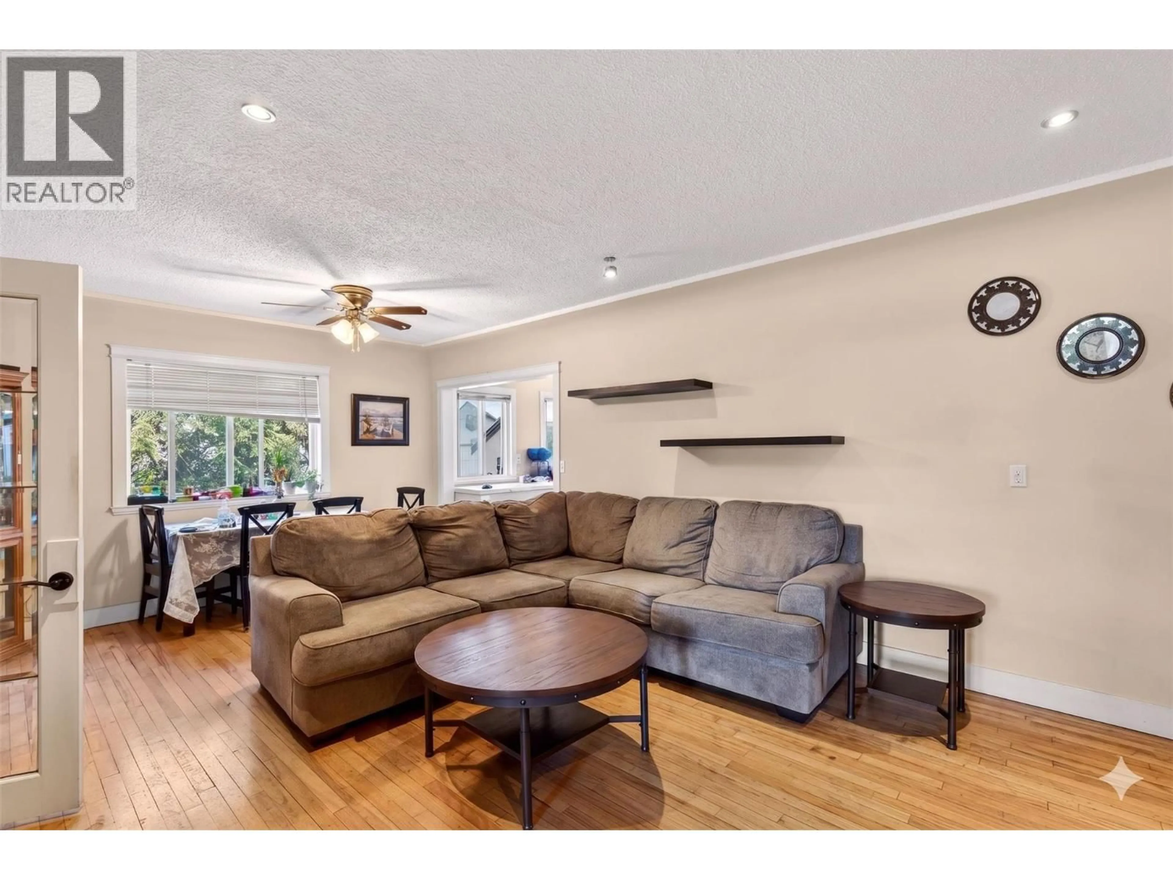 Living room with furniture, wood/laminate floor for 2435 RICHTER STREET, Kelowna British Columbia V1Y2P5