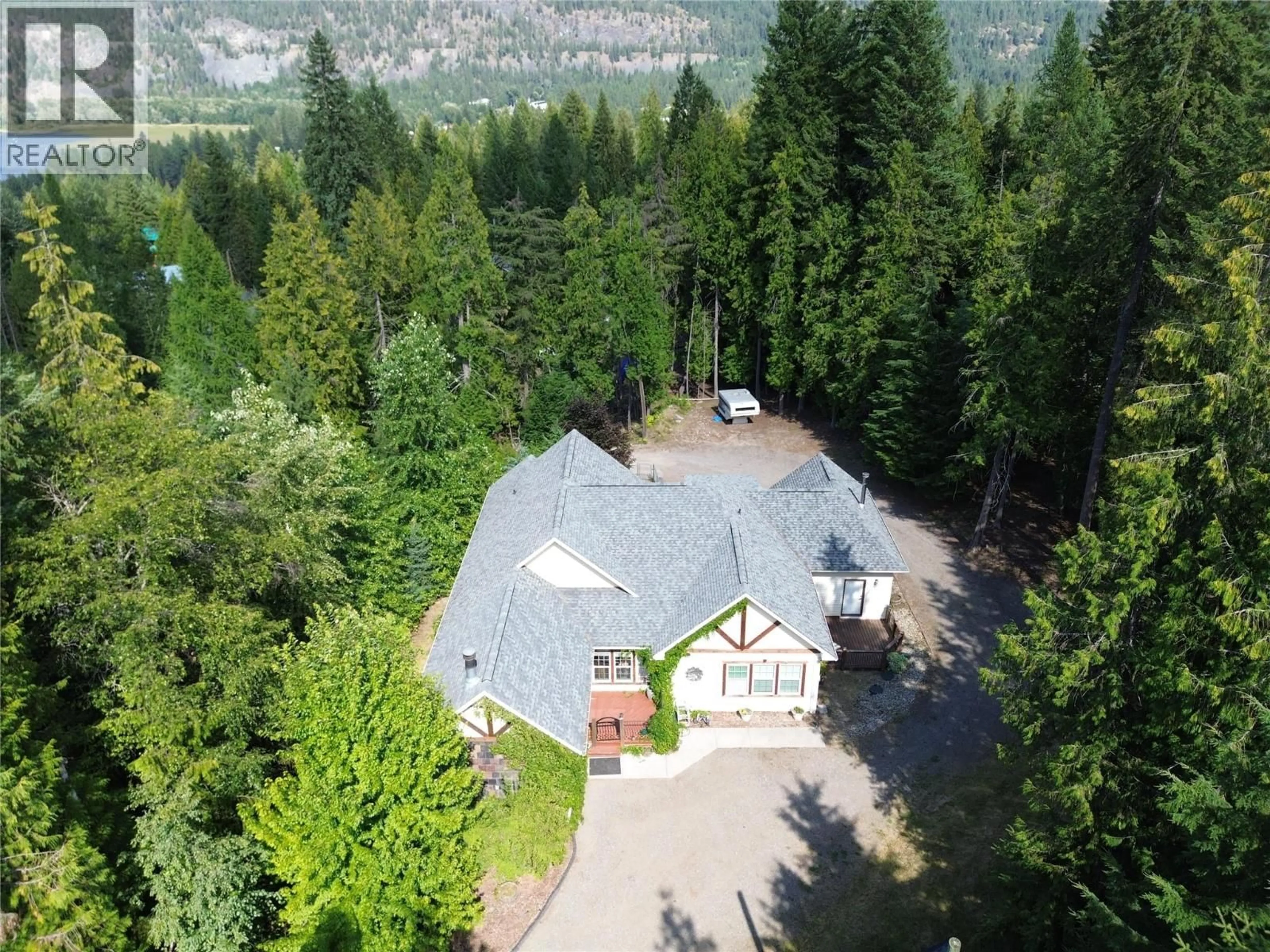 A pic from outside/outdoor area/front of a property/back of a property/a pic from drone, forest/trees view for 1615 BEECH ROAD, Christina Lake British Columbia V0H1E0
