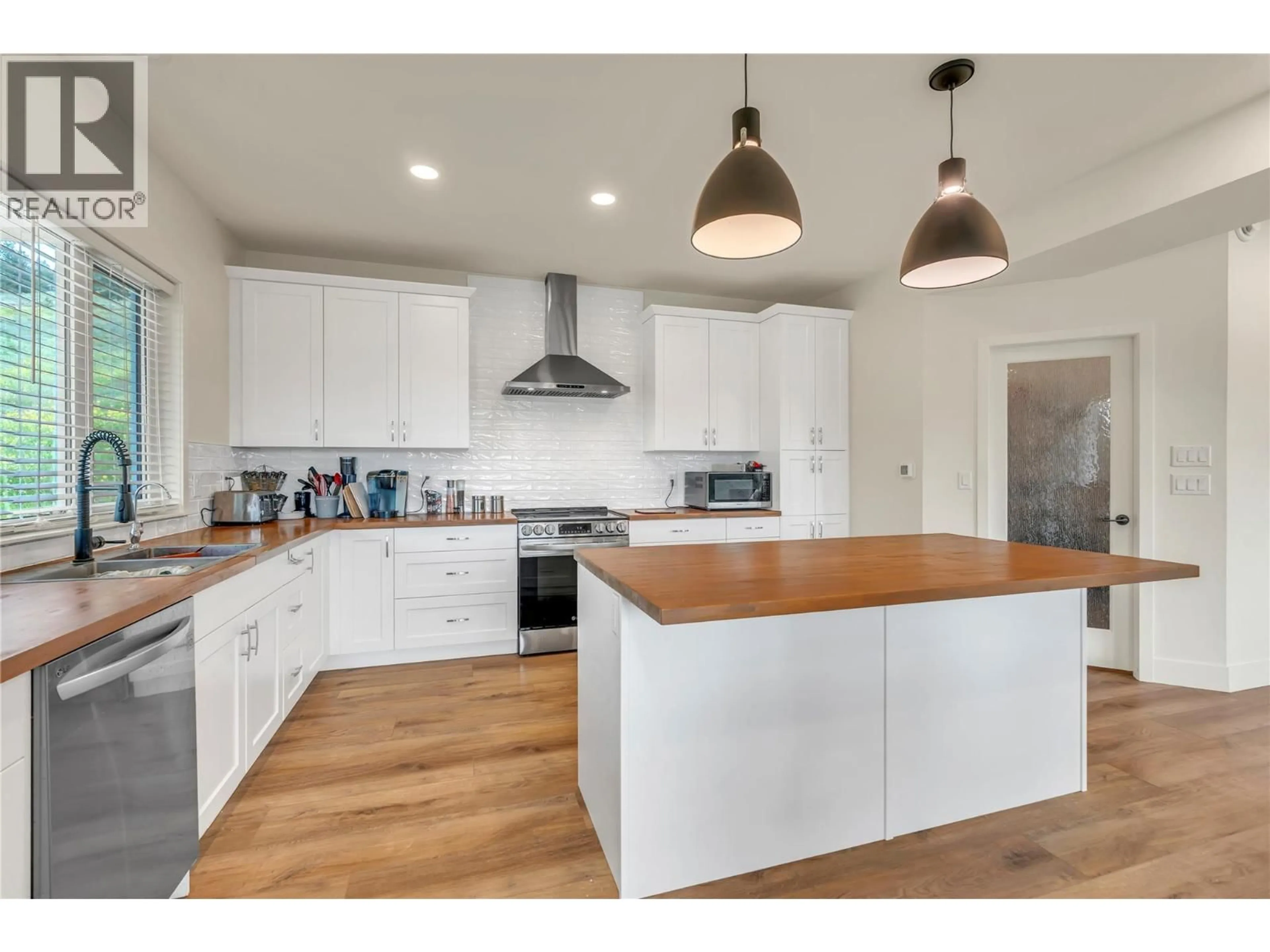 Open concept kitchen, wood/laminate floor for 318 HIDDEN VALLEY ROAD, Princeton British Columbia V0X1W0