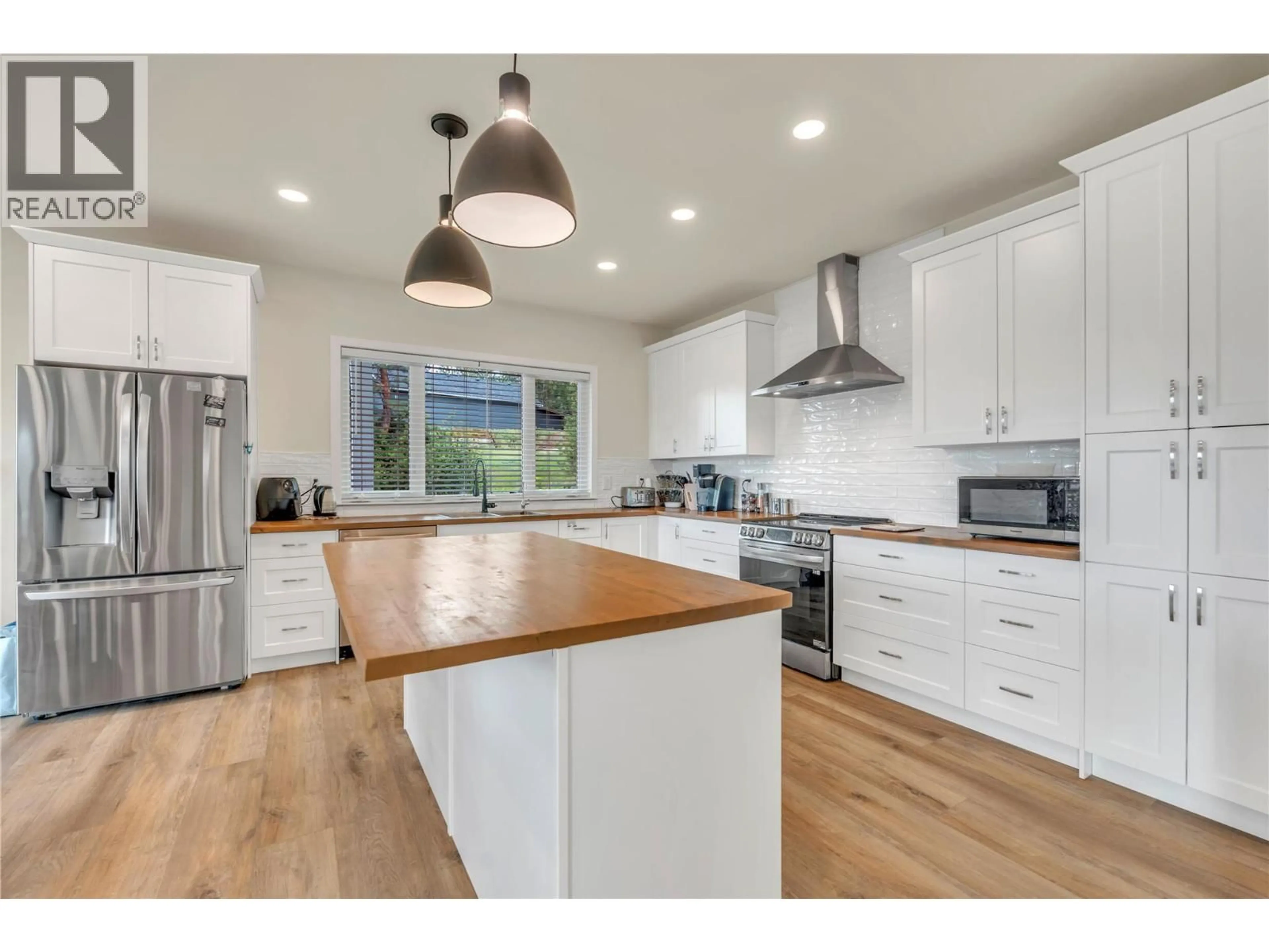 Open concept kitchen, wood/laminate floor for 318 HIDDEN VALLEY ROAD, Princeton British Columbia V0X1W0