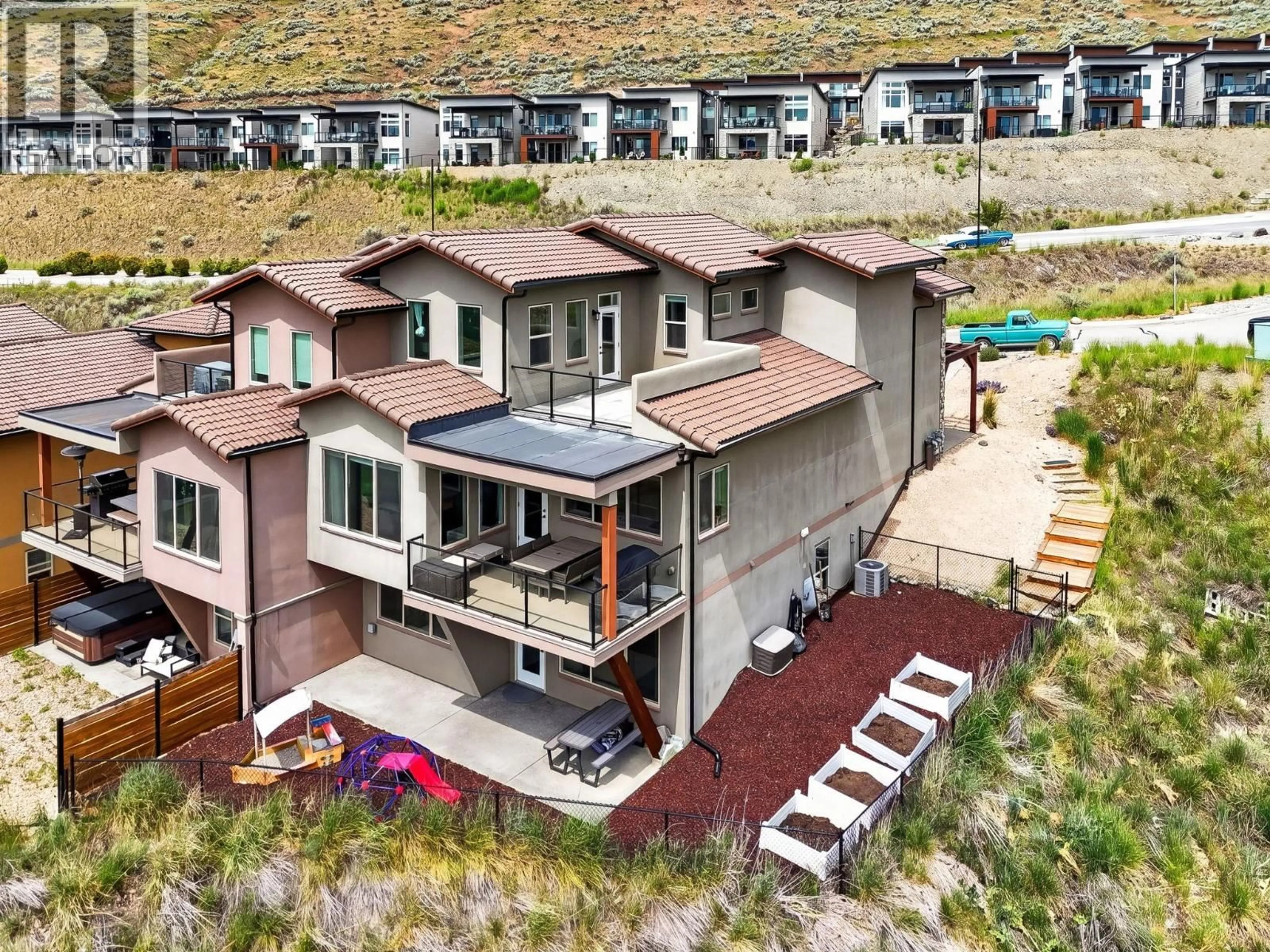 A pic from outside/outdoor area/front of a property/back of a property/a pic from drone, mountain view for 1 - 595 VINEYARD WAY NORTH, Vernon British Columbia V1H2M2