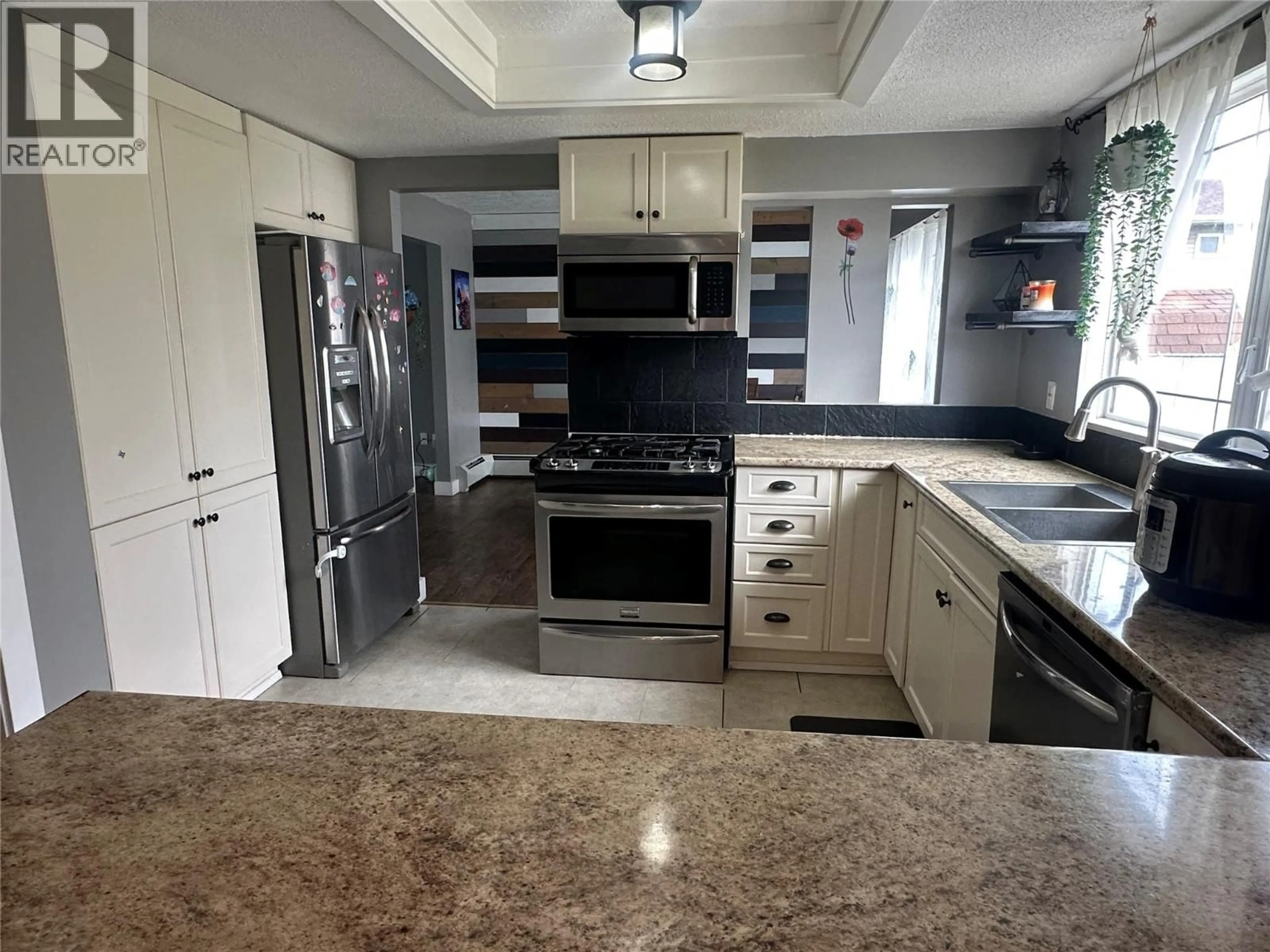 Open concept kitchen, ceramic/tile floor for 10692 COTTONWOOD CRESCENT, Dawson Creek British Columbia V1G4M4