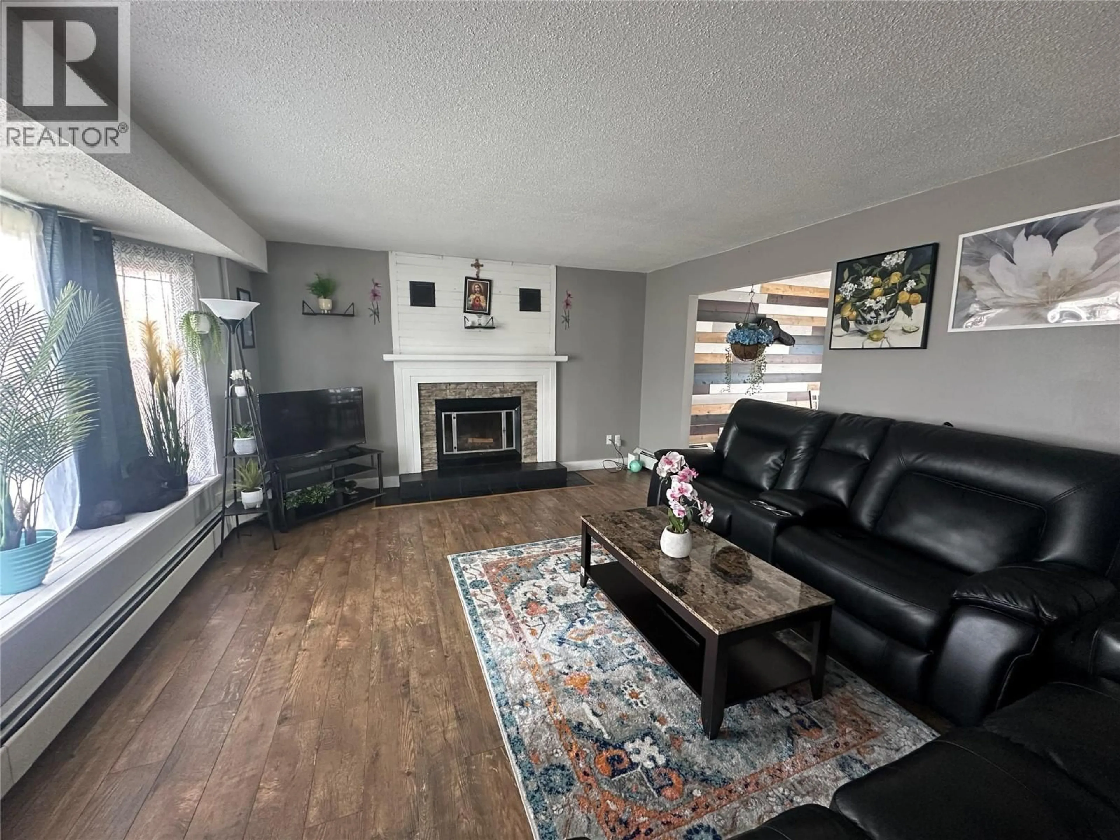 Living room with furniture, wood/laminate floor for 10692 COTTONWOOD CRESCENT, Dawson Creek British Columbia V1G4M4