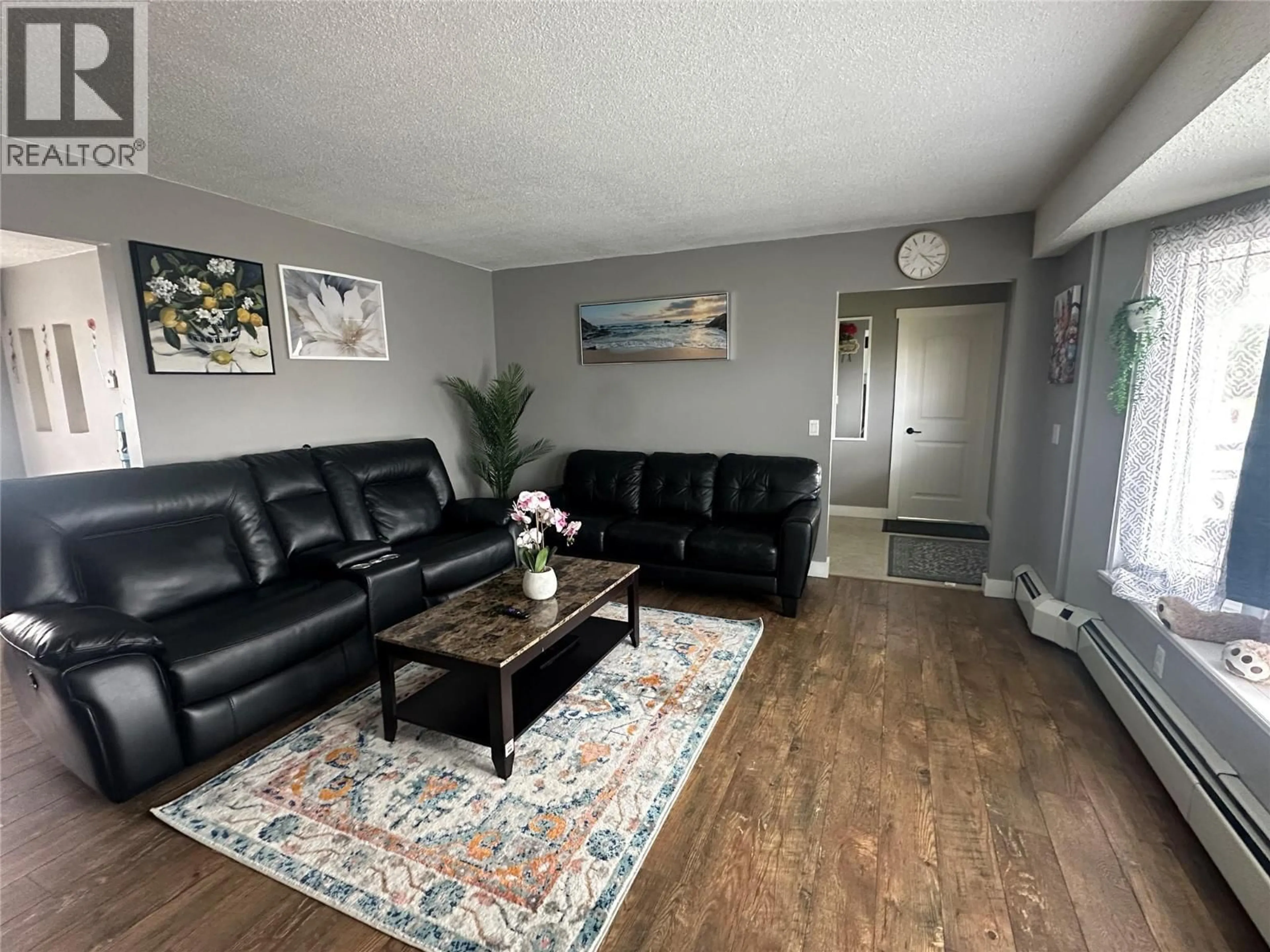 Living room with furniture, wood/laminate floor for 10692 COTTONWOOD CRESCENT, Dawson Creek British Columbia V1G4M4