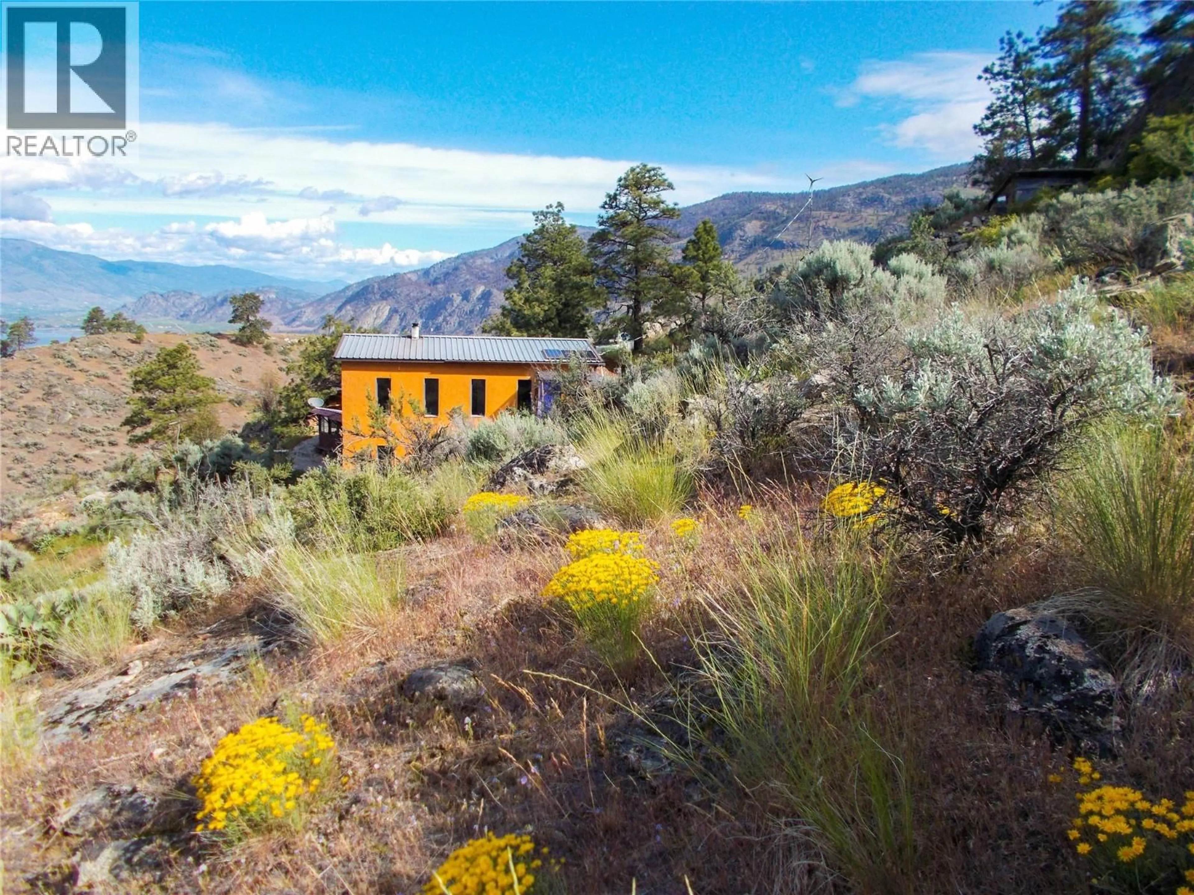 A pic from outside/outdoor area/front of a property/back of a property/a pic from drone, mountain view for 1345 3 HIGHWAY, Osoyoos British Columbia V0H1V6