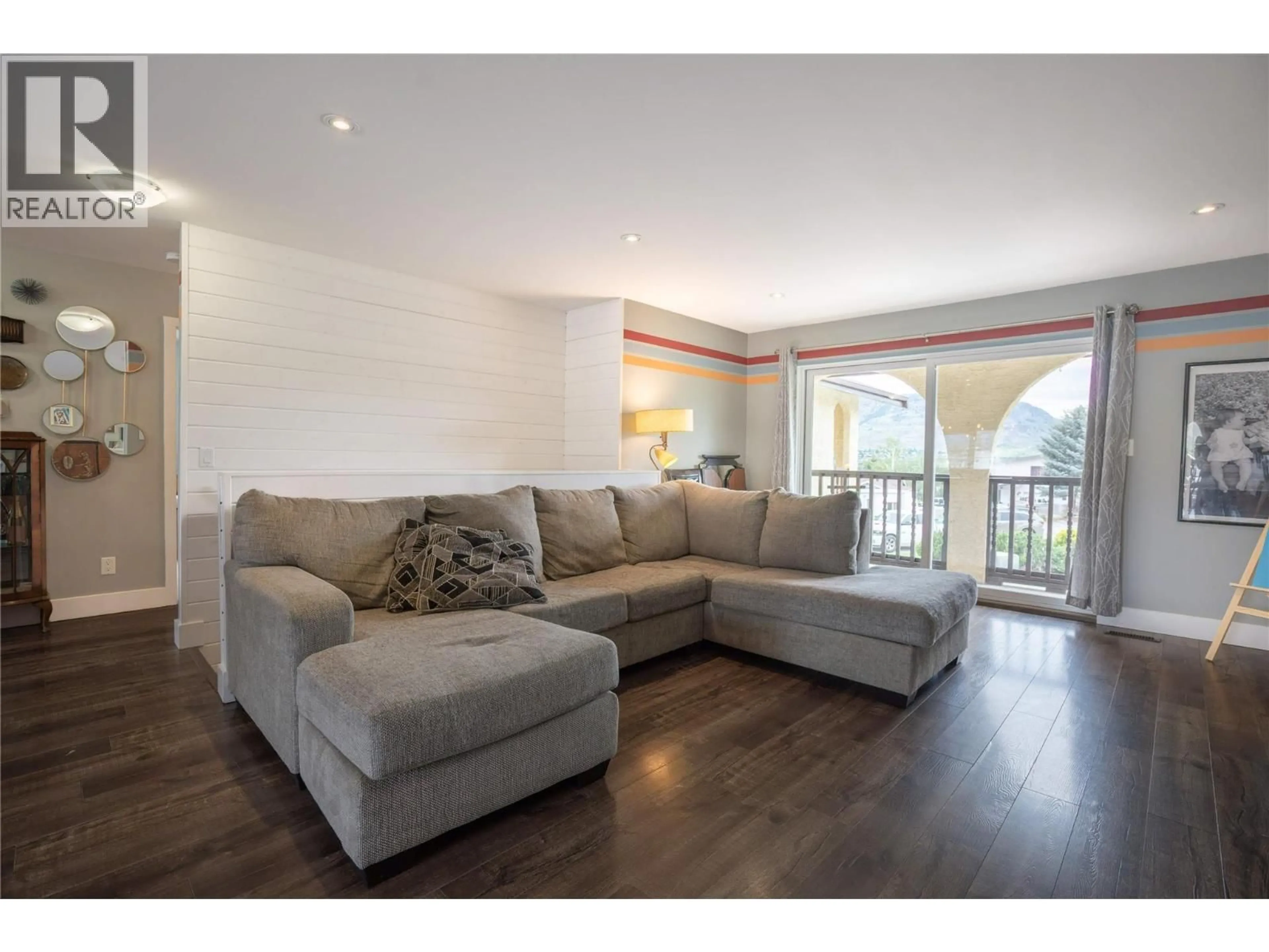 Living room with furniture, wood/laminate floor for 13 HEATHER PLACE, Osoyoos British Columbia V0H1V1